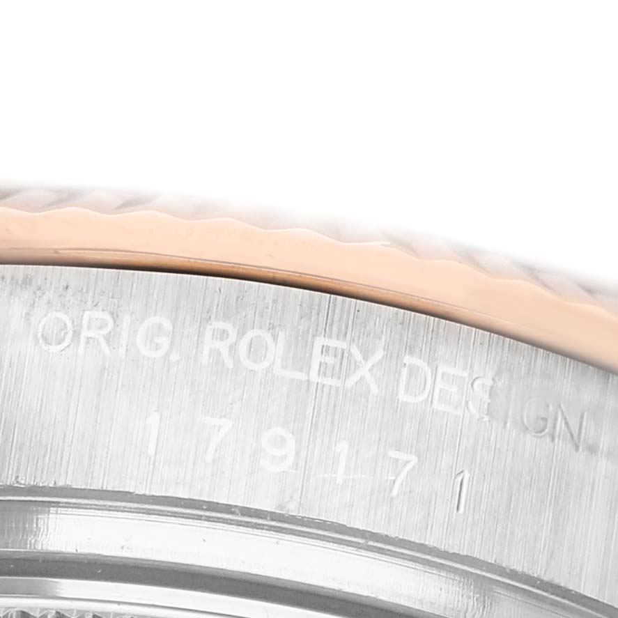 The image shows a close-up of the Rolex Datejust 179171 Women's Steel and Gold (two tone) Silver Dial model's case, highlighting engraved details.