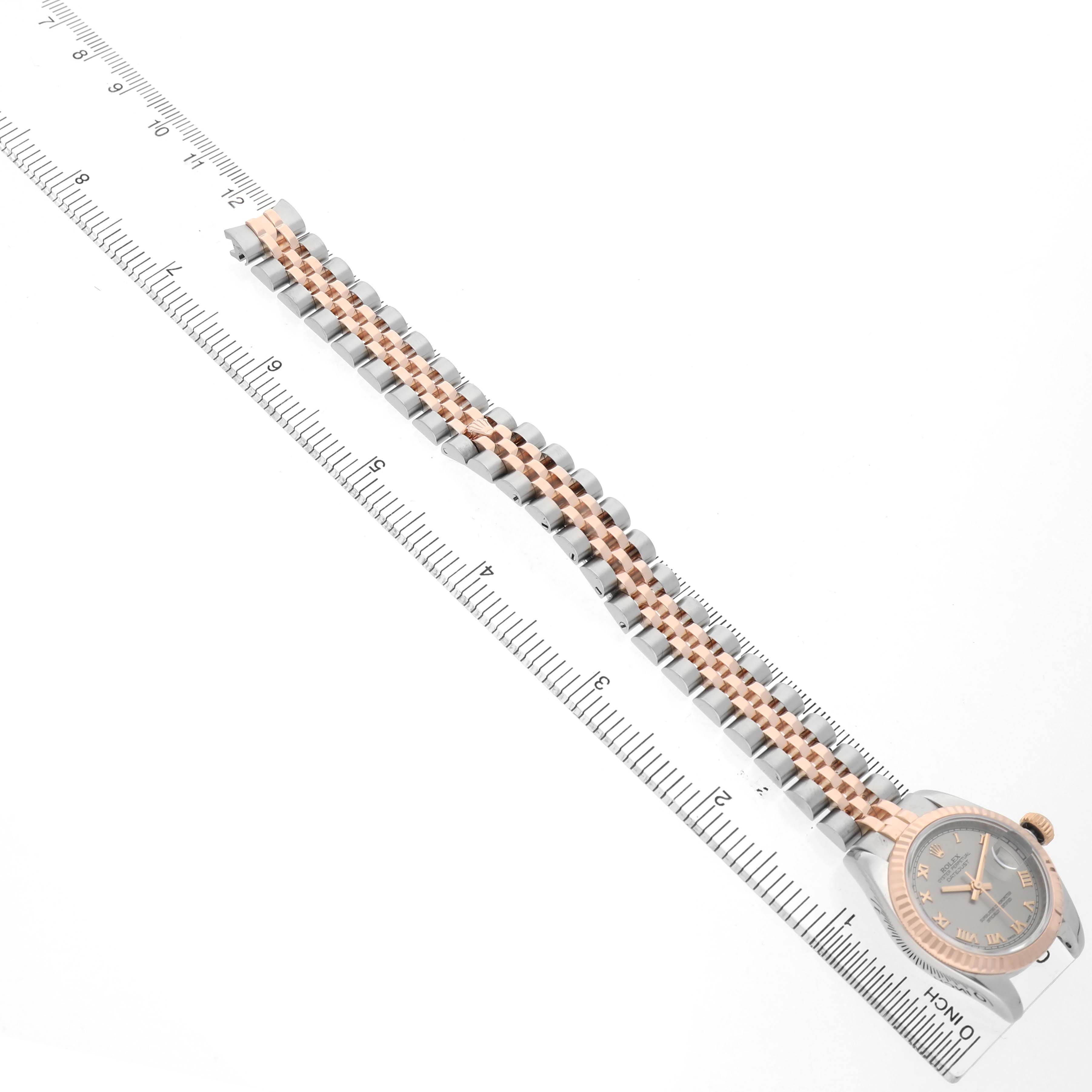 The Rolex Datejust 179171 Women's Steel and Gold (two tone) Silver Dial watch is shown from an overhead angle, displaying the full bracelet and case.