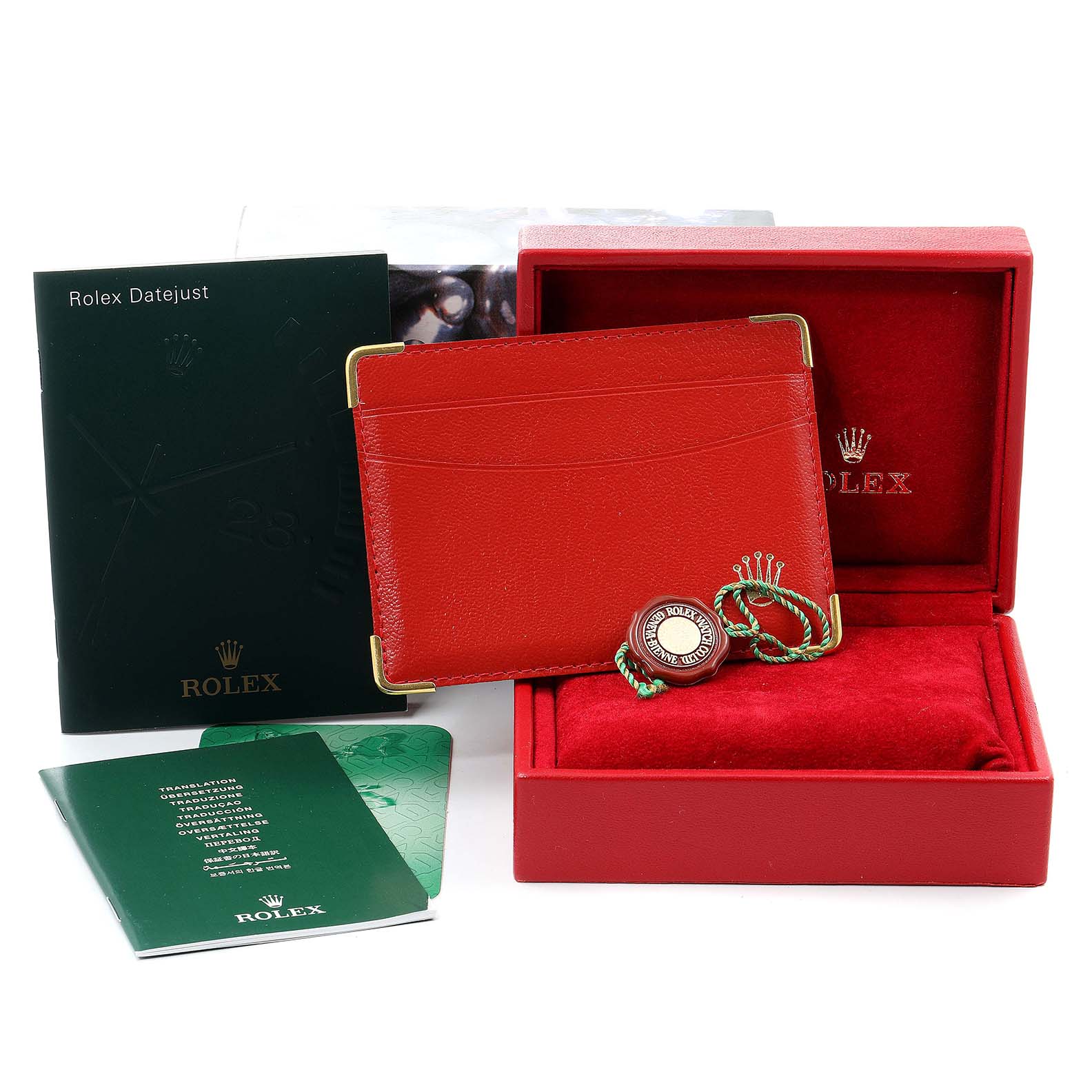 The image shows accessories for a Rolex Datejust 69173 Women's Steel and Gold (two tone) Champagne Dial 69173 Women's Steel and Gold (two tone) Champagne Dial, including a green booklet, red cardholder, tag, and red box.