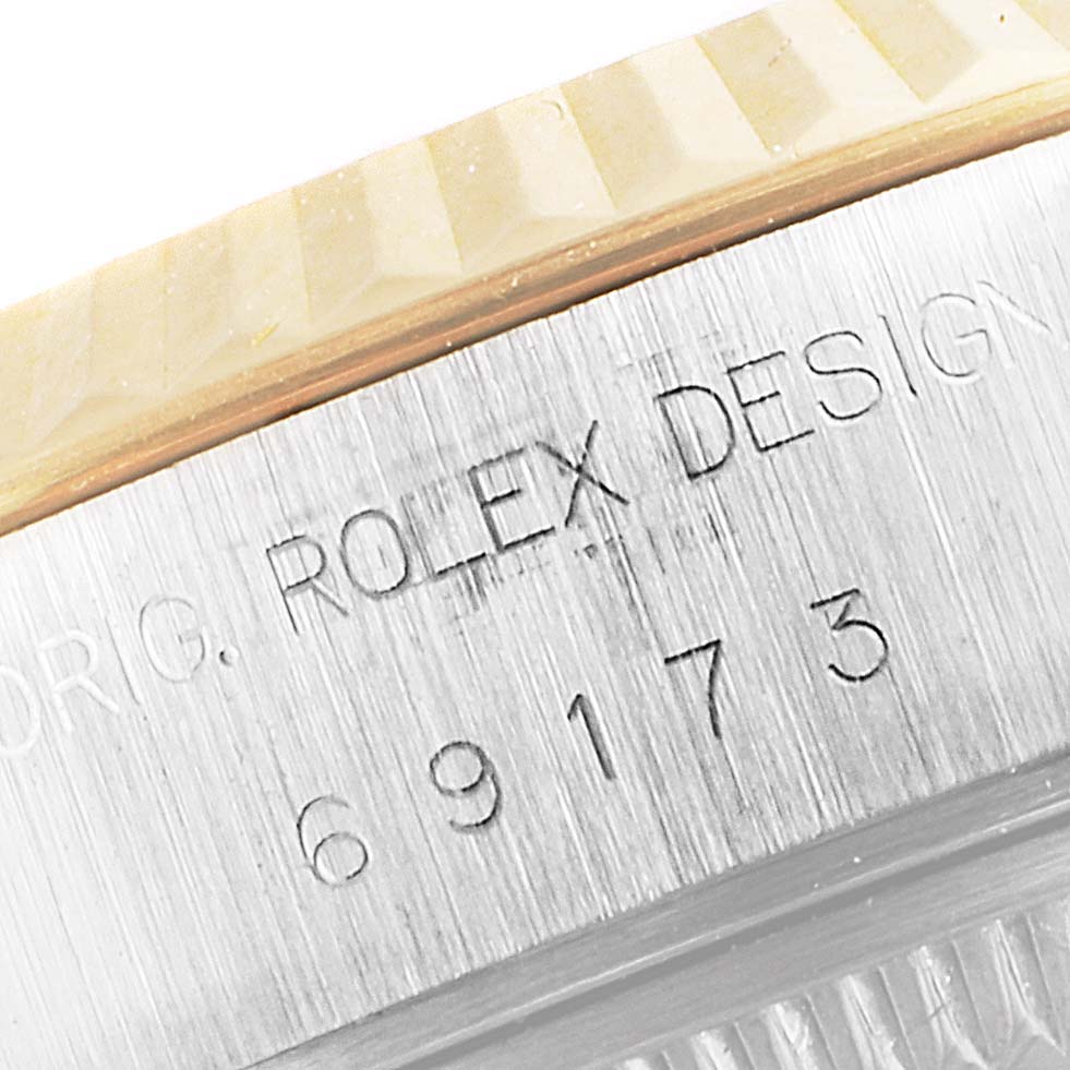 Close-up of the serial and model number engraving on the side of the Rolex Datejust 69173 Women's Steel and Gold (two tone) Champagne Dial 69173 Women's Steel and Gold (two tone) Champagne Dial watch case.