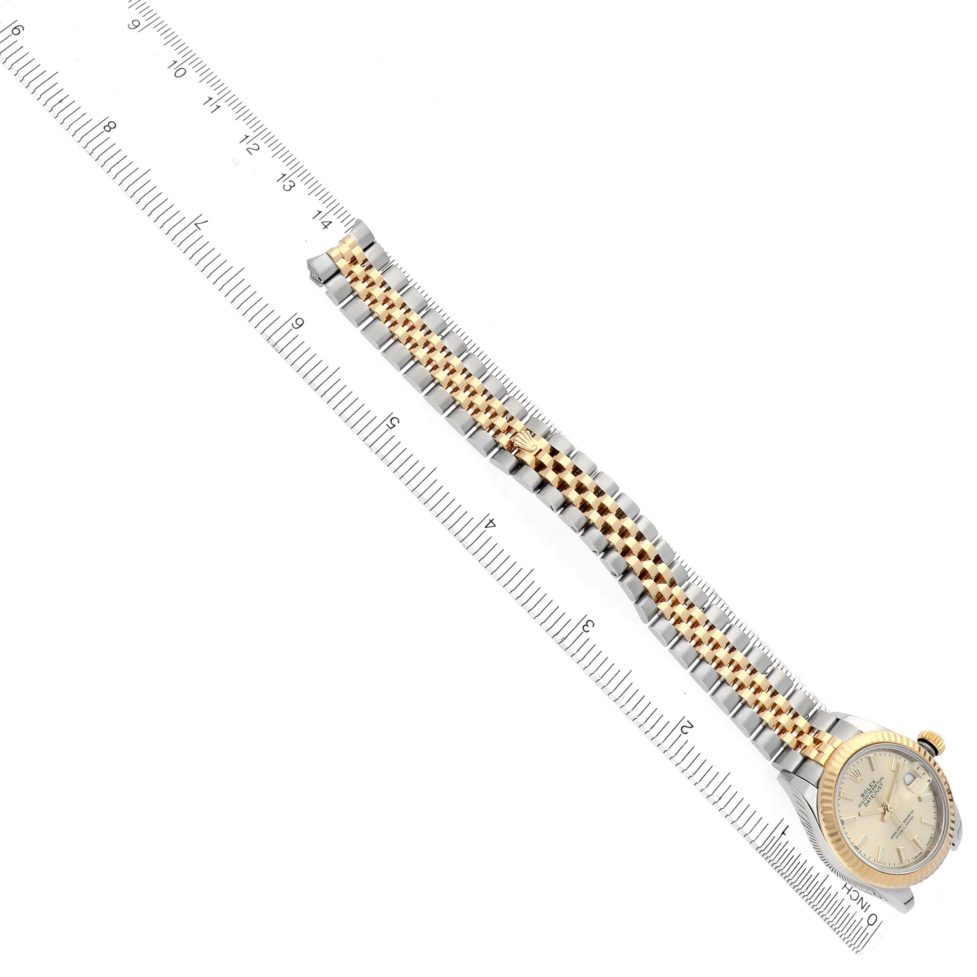 The image shows a Rolex Datejust 279173 Women's Steel and Gold (two tone) Champagne Dial 279173 Women's Steel and Gold (two tone) Champagne Dial watch at an angled view, displaying the face and full bracelet next to a ruler.