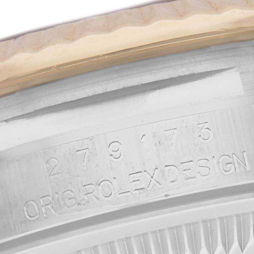 The image shows a close-up of the edge of a Rolex Datejust 279173 Women's Steel and Gold (two tone) Champagne Dial 279173 Women's Steel and Gold (two tone) Champagne Dial, focusing on the serial number and "Orig Rolex Design" engraving.