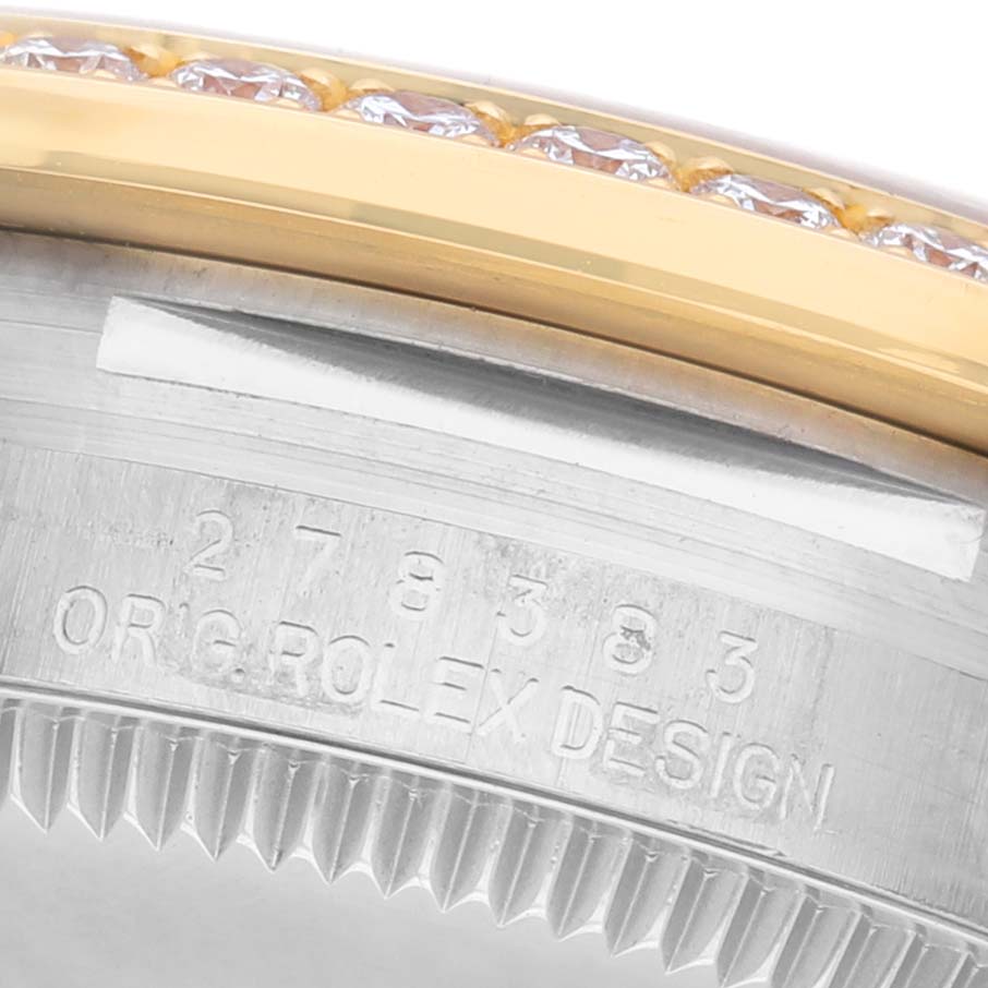 The image shows the side of a Rolex Mid-Size 278383RBR Women's Steel and Gold (two tone) Mother of Pearl Dial watch with part of the engraved model number and a gold bezel with diamonds.