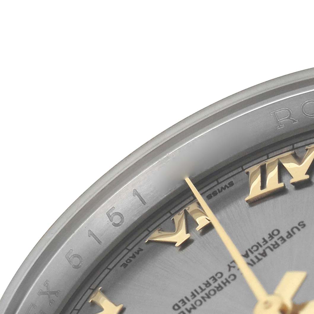 This close-up image shows the edge of the dial, bezel, and part of the golden Roman numerals on a Rolex Datejust 116233 Men's Steel and Gold (two tone) Grey Dial watch.