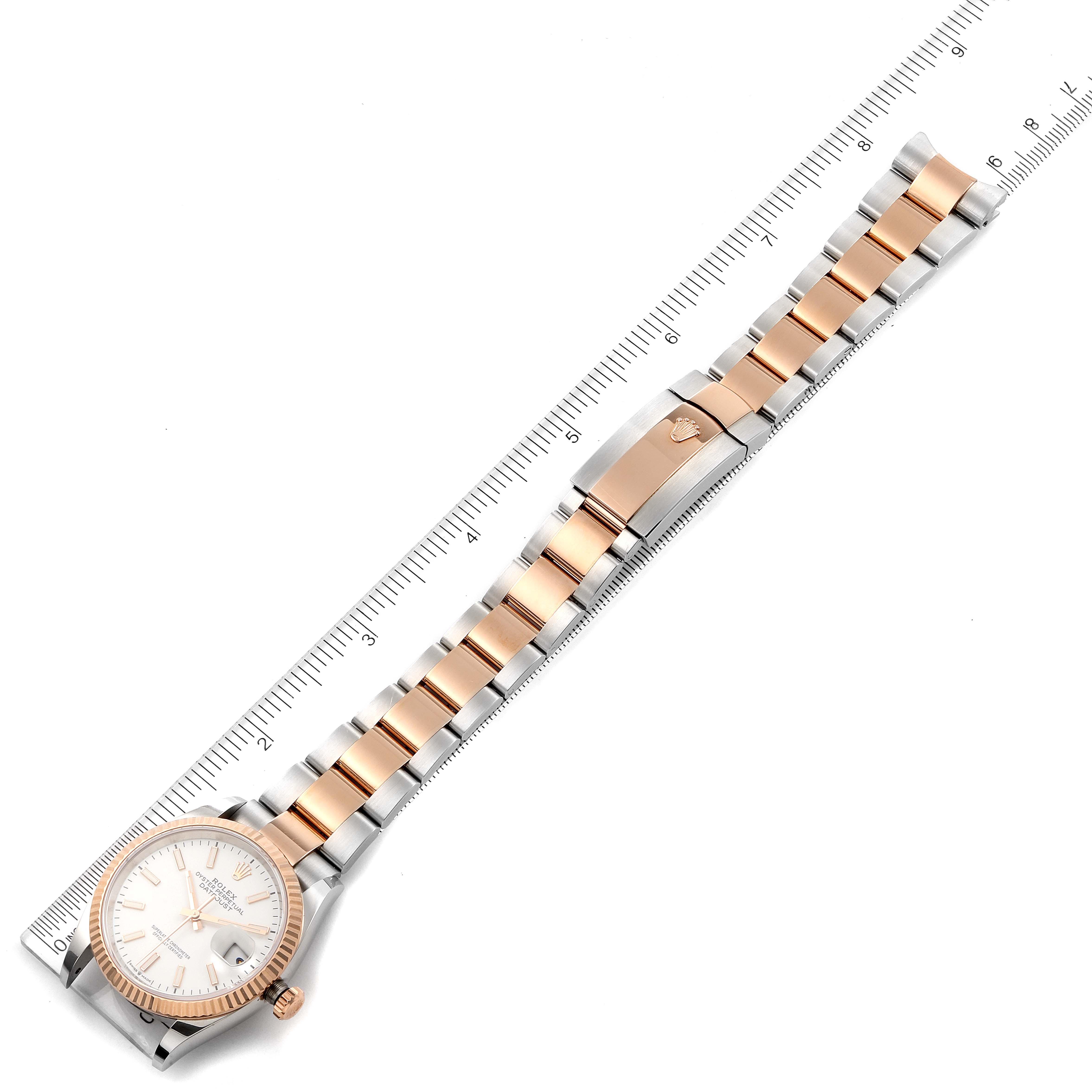 The image shows a Rolex Datejust 126231 Men's Steel and Gold (two tone) White Dial 126231 Men's Steel and Gold (two tone) White Dial watch from an overhead angle, displaying its dial, strap, and clasp.