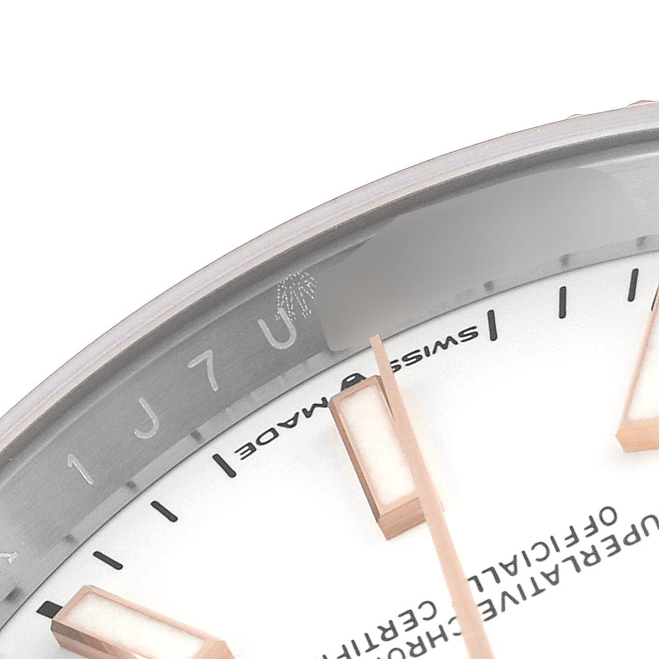 This image shows a close-up of the dial of a Rolex Datejust 126231 Men's Steel and Gold (two tone) White Dial 126231 Men's Steel and Gold (two tone) White Dial watch, focusing on the indices and the text "Swiss Made."