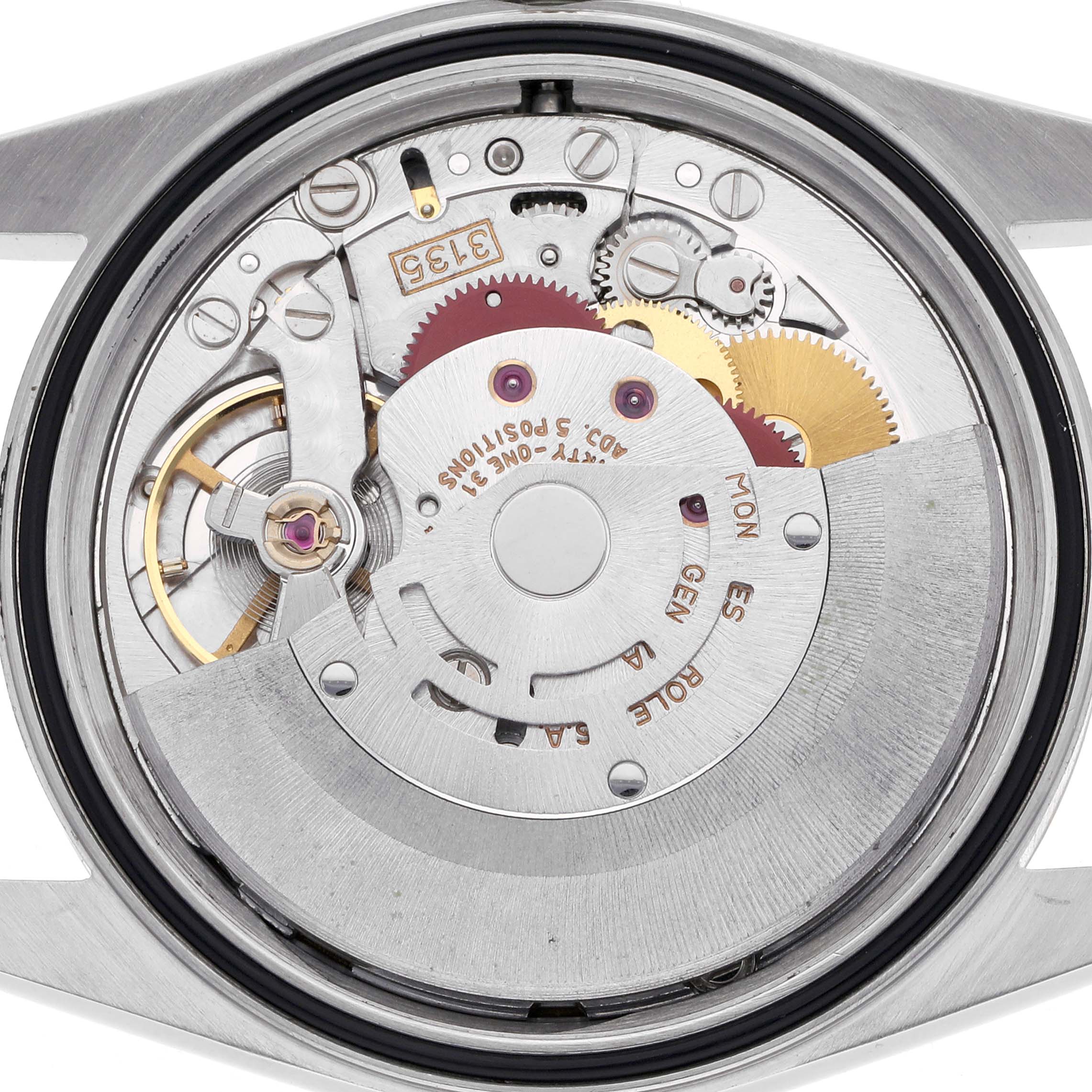 The image shows the movement of a Rolex Datejust 16233 Men
s Steel and Gold (two tone) Champagne Dial 16233 Men
s Steel and Gold (two tone) Champagne Dial, viewed from the back, highlighting its intricate gears and rotor.