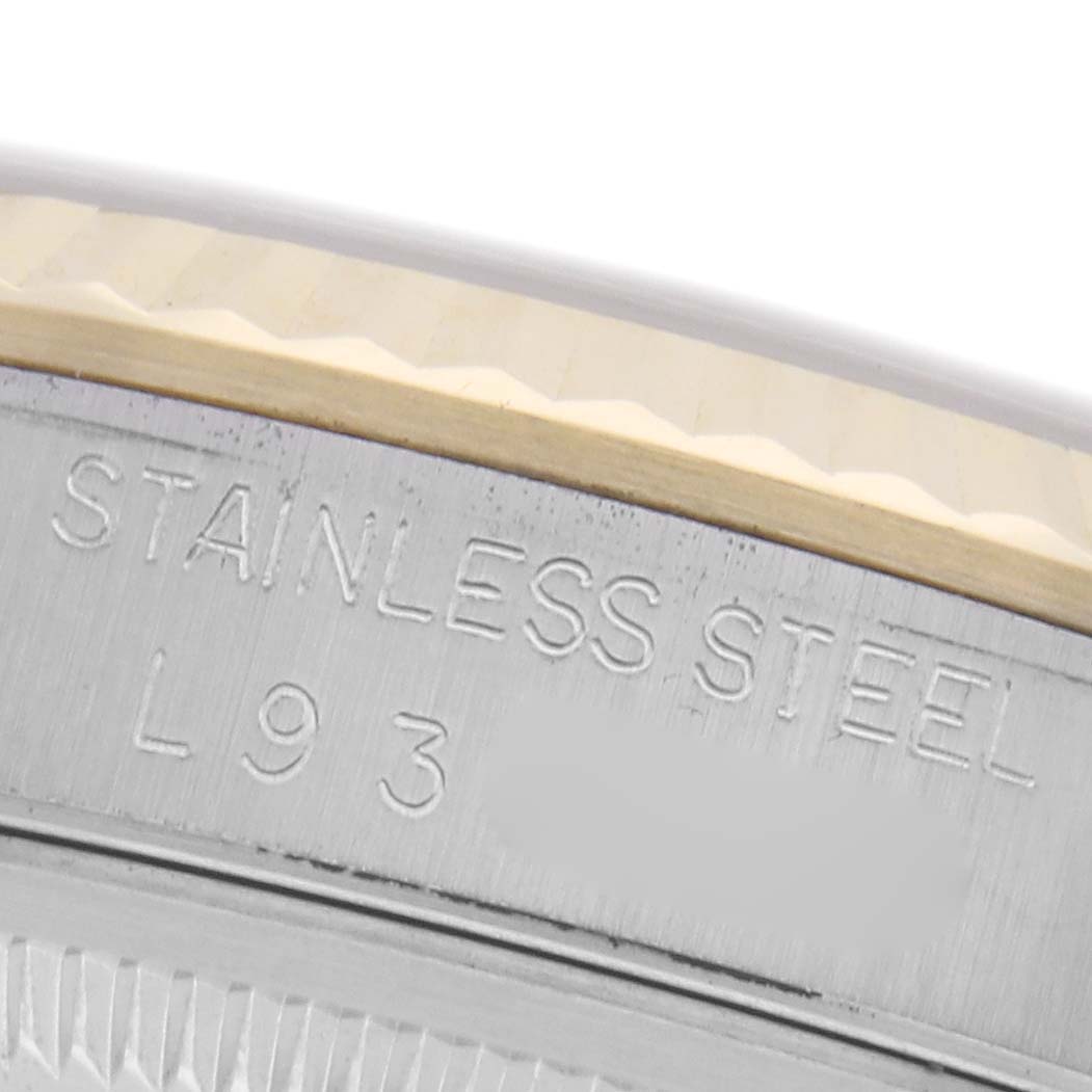 The image shows a close-up of the stainless steel outer rim with engraved text on a Rolex Datejust 16233 Men
s Steel and Gold (two tone) Champagne Dial 16233 Men
s Steel and Gold (two tone) Champagne Dial.
