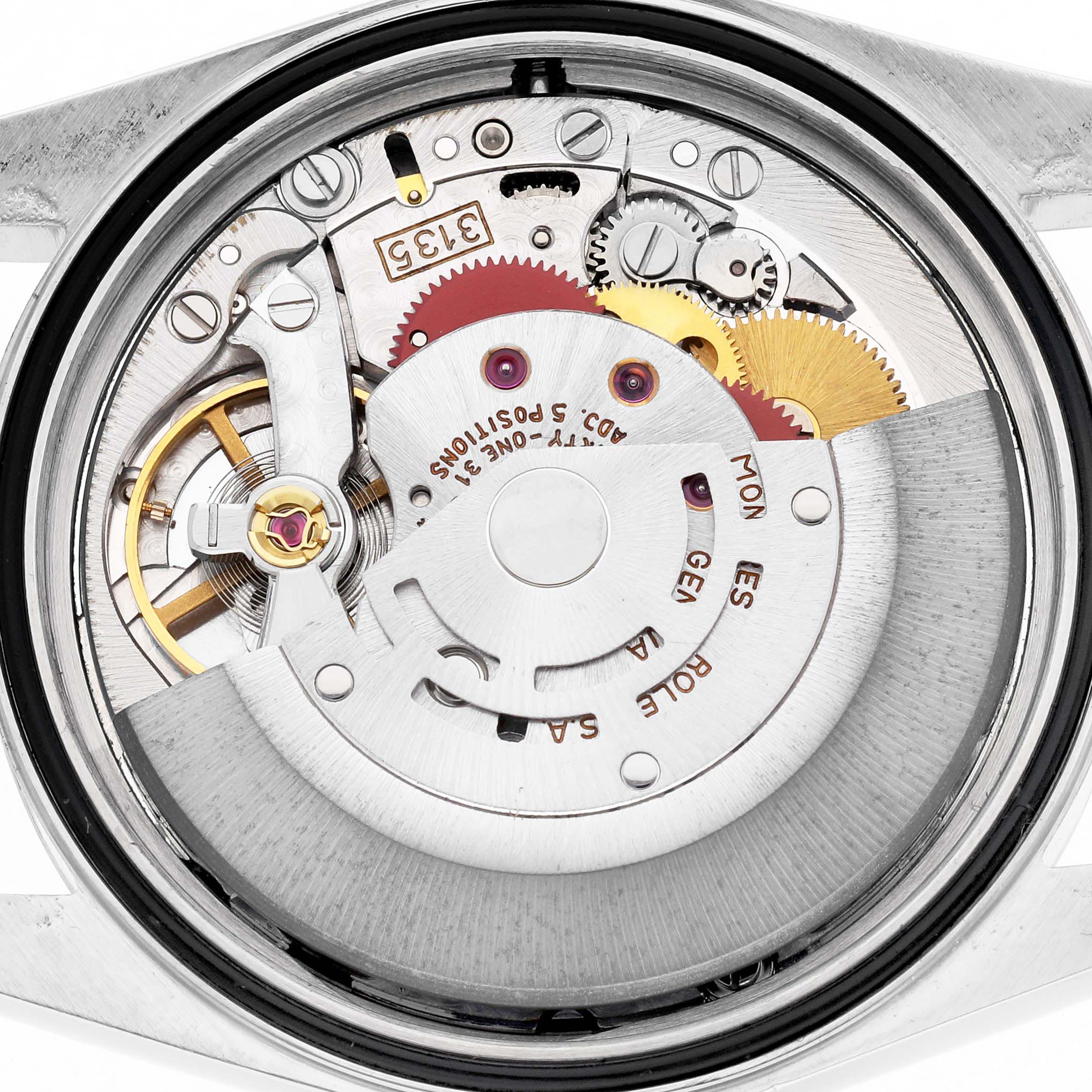 The image shows the movement of a Rolex Datejust 16233 Men's Steel and Gold (two tone) Champagne Dial 16233 Men's Steel and Gold (two tone) Champagne Dial watch from the back, revealing gears and components.