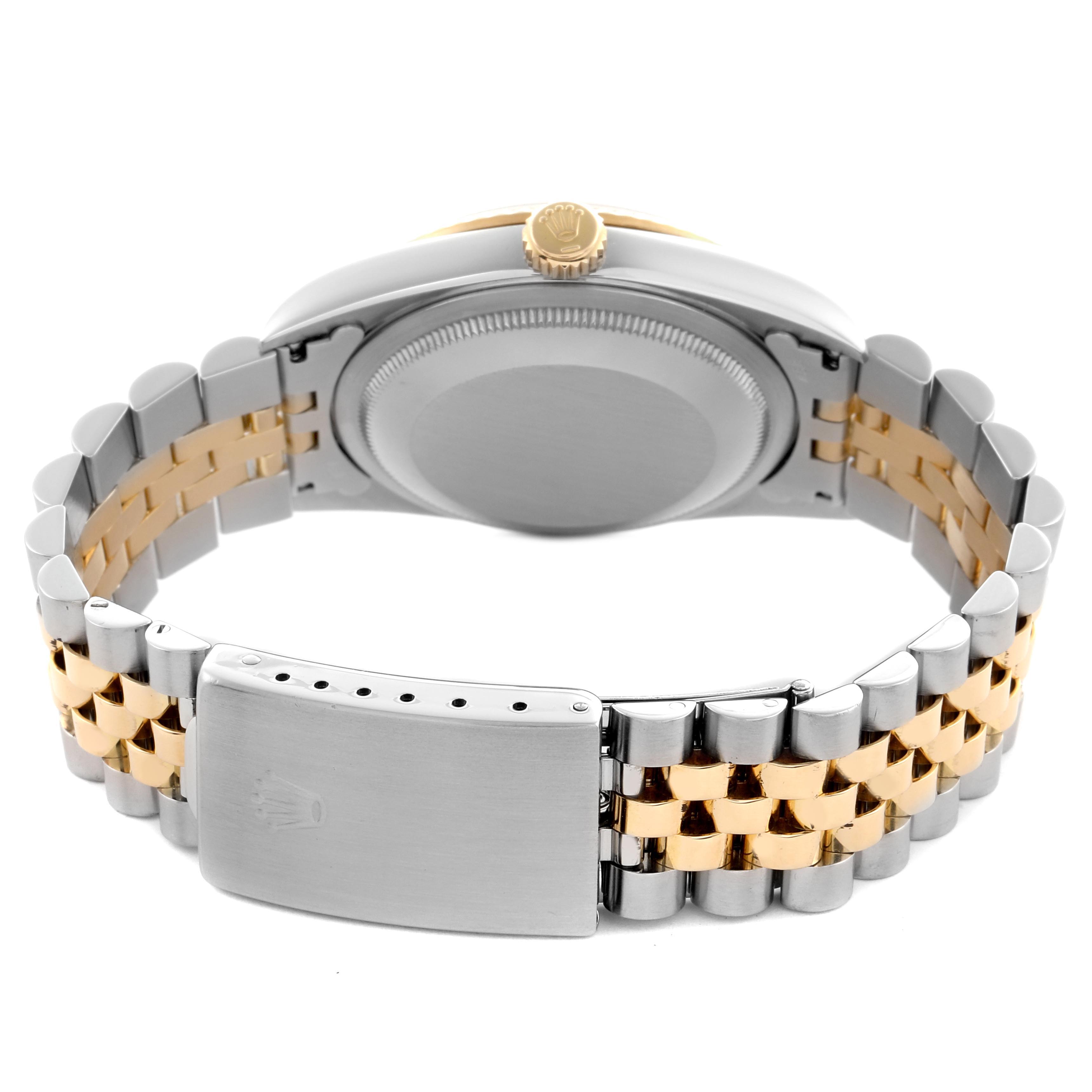 The image shows the back case and two-tone bracelet of a Rolex Datejust 16233 Men's Steel and Gold (two tone) Silver Dial 16233 Men's Steel and Gold (two tone) Silver Dial, highlighting its clasp and crown from a rear angle.