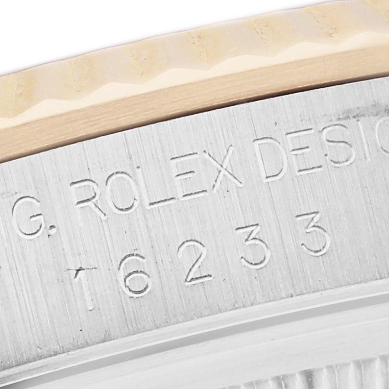 The image shows a close-up of the engraved side of a Rolex Datejust 16233 Men's Steel and Gold (two tone) Silver Dial 16233 Men's Steel and Gold (two tone) Silver Dial watch case, highlighting the reference number and design details.
