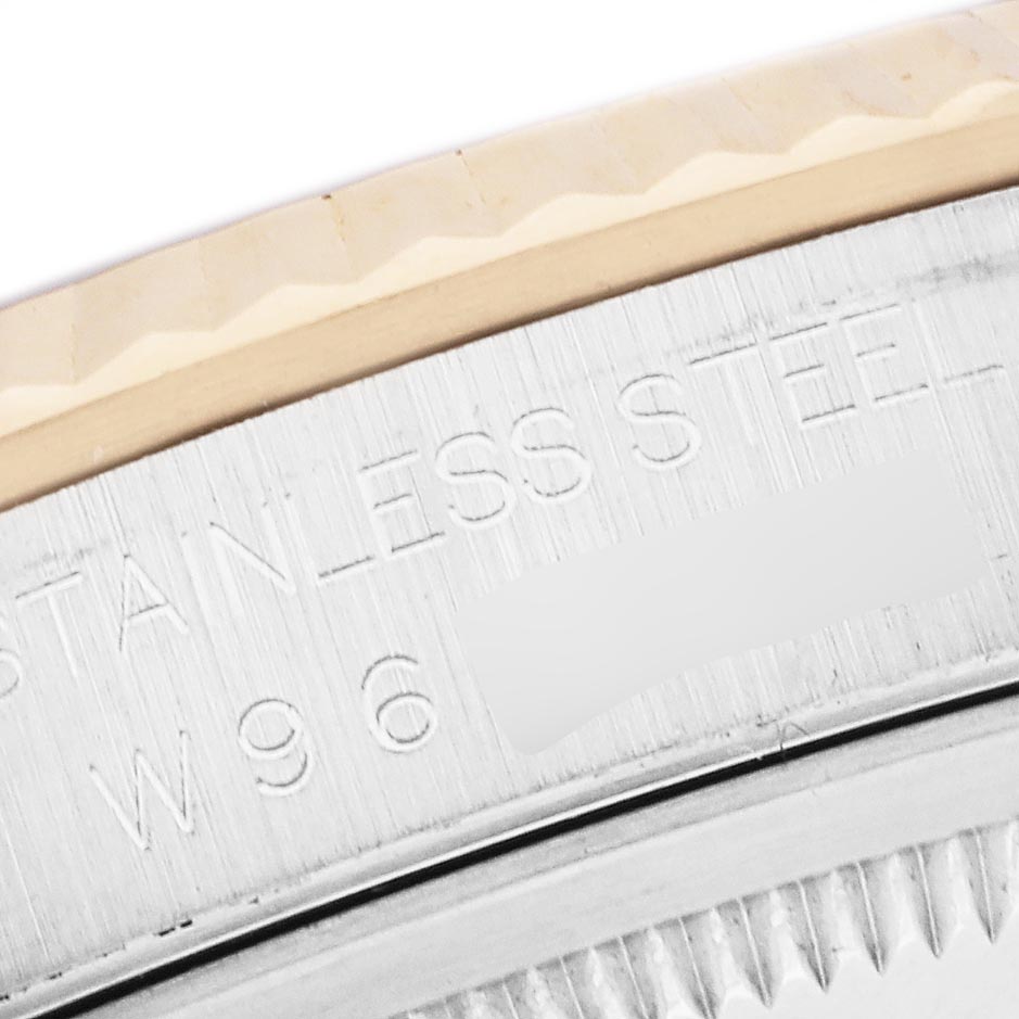 The image shows a close-up of the side of a Rolex Datejust 16233 Men's Steel and Gold (two tone) Silver Dial 16233 Men's Steel and Gold (two tone) Silver Dial case, focusing on the engraving and fluted bezel.