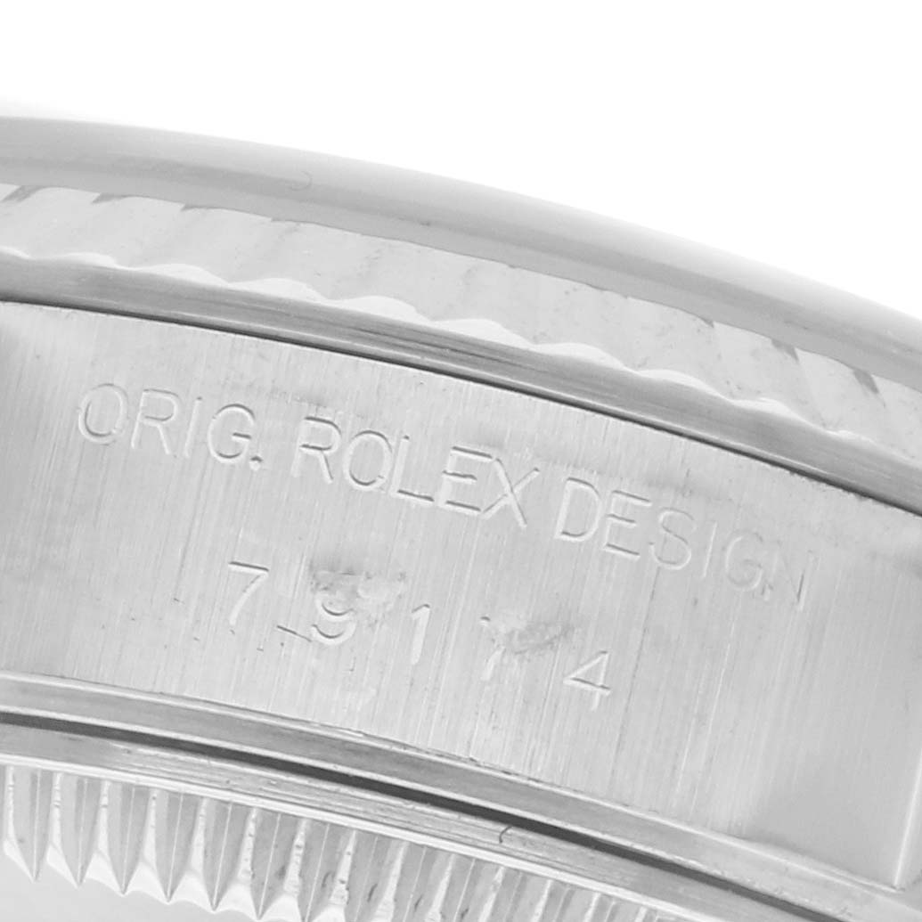 The image shows the side of a Rolex Datejust 79174 Women's Stainless Steel Silver Dial 79174 Women's Stainless Steel Silver Dial watch case, highlighting the model number and "ORIG. ROLEX DESIGN" engraving.