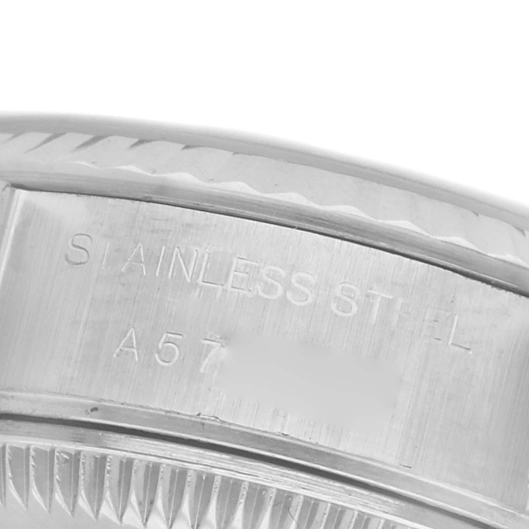 The image shows a close-up of the side of the case, showcasing the engraved "STAINLESS STEEL" on the Rolex Datejust 79174 Women's Stainless Steel Silver Dial 79174 Women's Stainless Steel Silver Dial watch.