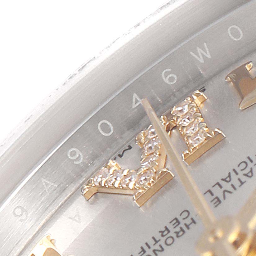 This image shows a close-up of the dial and hand of a Mid-Size Rolex watch, highlighting the hour markers and part of the bezel.