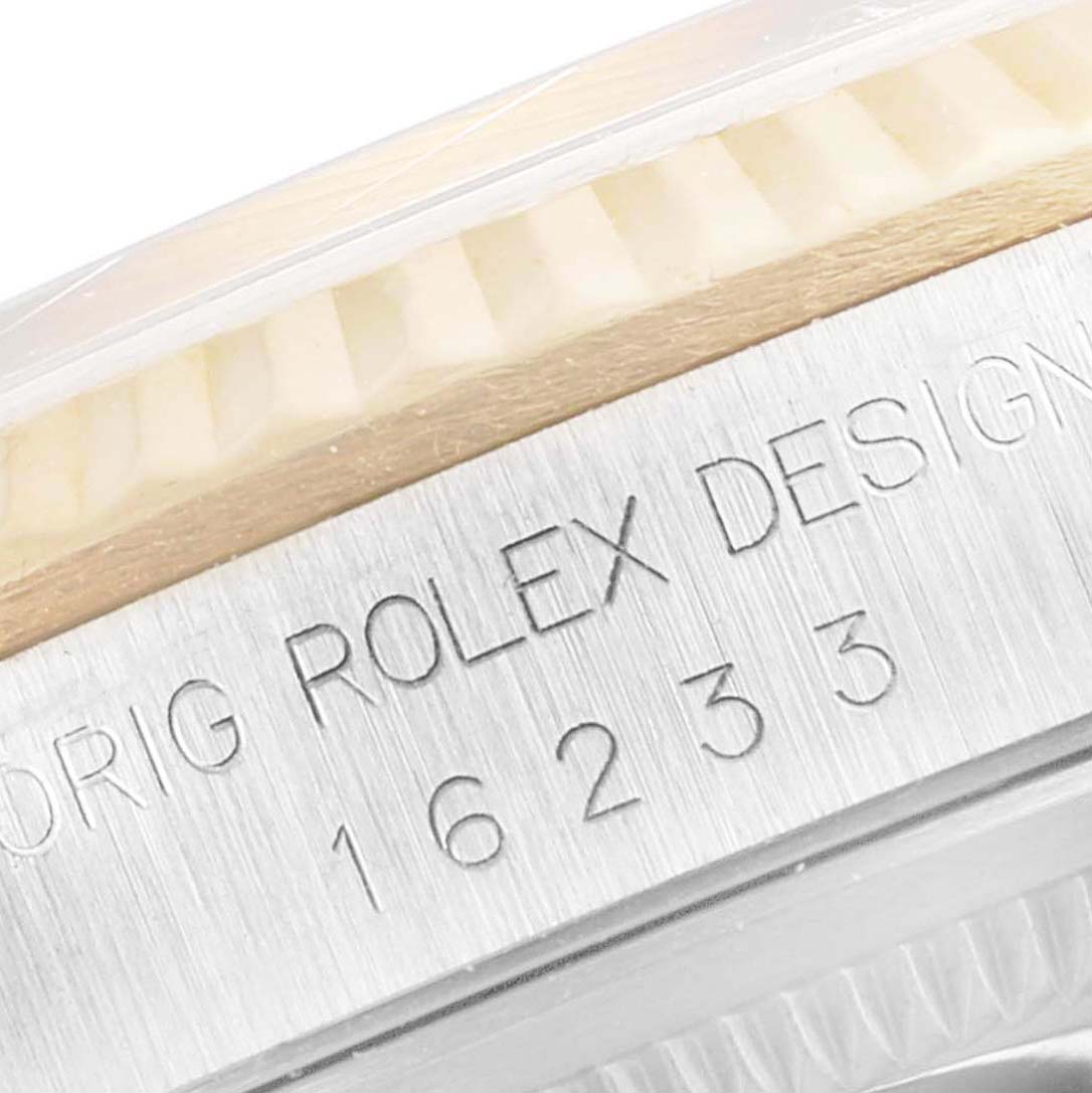 This image shows the side of the Rolex Datejust 16233 Men's Steel and Gold (two tone) White Dial 16233 Men's Steel and Gold (two tone) White Dial model, highlighting the engraved serial number and part of the bezel.