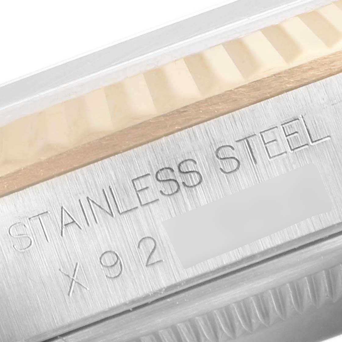 The image shows a close-up of the stainless steel case with engraved text on a Rolex Datejust 16233 Men's Steel and Gold (two tone) White Dial 16233 Men's Steel and Gold (two tone) White Dial watch.