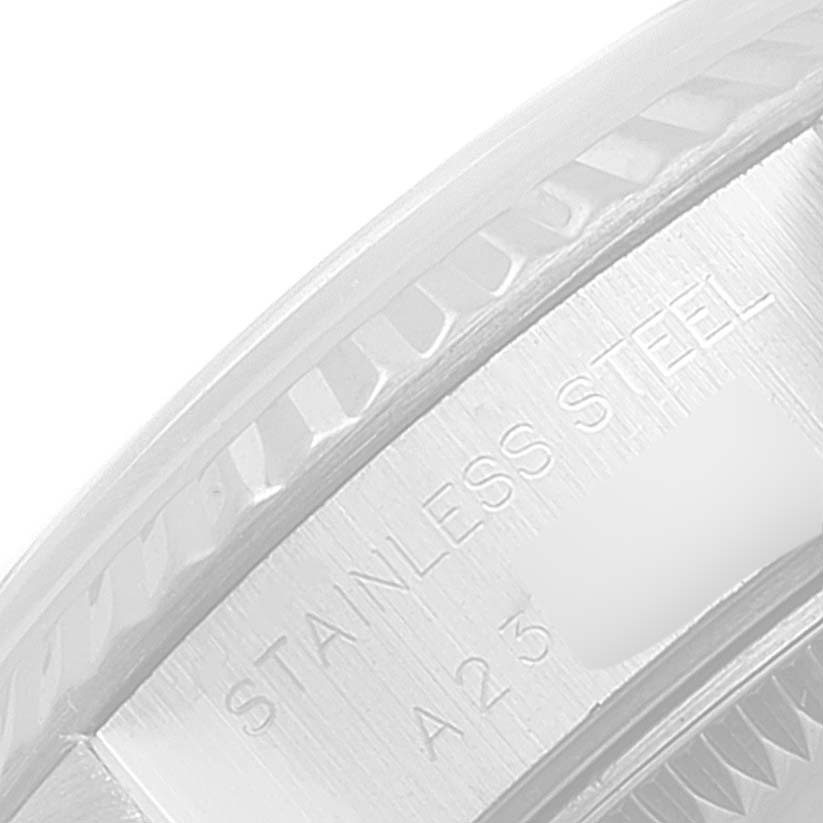 This close-up shows the stainless steel casing and part of the fluted bezel of a Rolex Datejust 79174 Women's Stainless Steel Black Dial 79174 Women's Stainless Steel Black Dial watch.