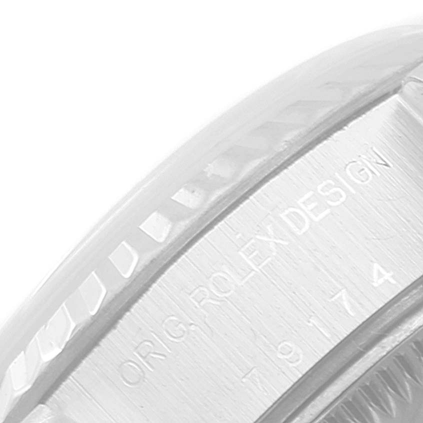 The image shows a close-up angle of the bezel and engraved edge of a Rolex Datejust 79174 Women's Stainless Steel White Dial 79174 Women's Stainless Steel White Dial watch.