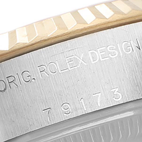 This close-up shows the bezel and the engraved case of a Rolex Datejust 79173 Women's Steel and Gold (two tone) Mother of Pearl Dial 79173 Women's Steel and Gold (two tone) Mother of Pearl Dial watch.