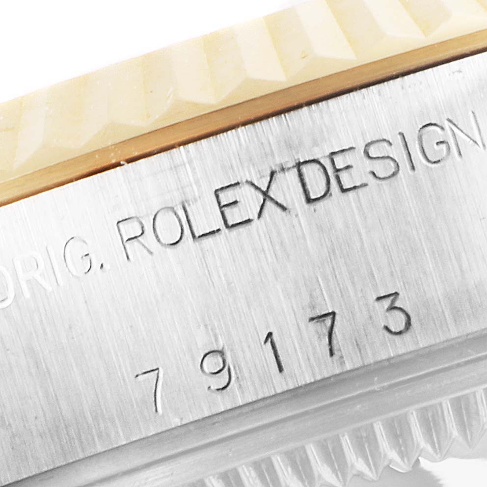 The image shows a close-up of the case side of a Rolex Datejust 79173 Women's Steel and Gold (two tone) Black Dial 79173 Women's Steel and Gold (two tone) Black Dial watch, displaying the "ROLEXDESIGN" engraving and model number 79173.