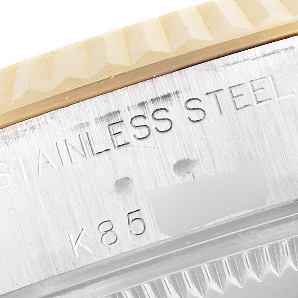 The image shows a macro view of the Rolex Datejust 79173 Women's Steel and Gold (two tone) Black Dial 79173 Women's Steel and Gold (two tone) Black Dial watch's stainless steel case side and part of its bezel.