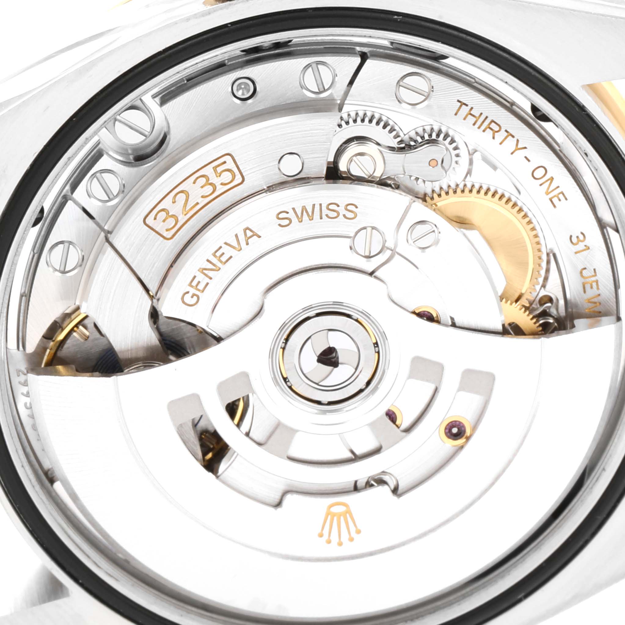 The image shows the movement and internal mechanism of a Rolex Datejust 126233 Men's Steel and Gold (two tone) Silver Dial 126233 Men's Steel and Gold (two tone) Silver Dial watch, including gears and the rotor.
