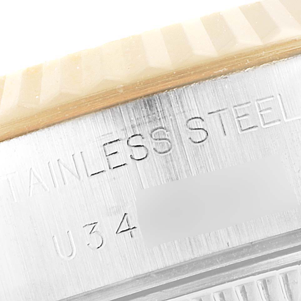 This close-up of a Rolex Datejust 69173 Women's Steel and Gold (two tone) Mother of Pearl Dial 69173 Women's Steel and Gold (two tone) Mother of Pearl Dial watch shows the stainless steel engraving and part of the bezel.