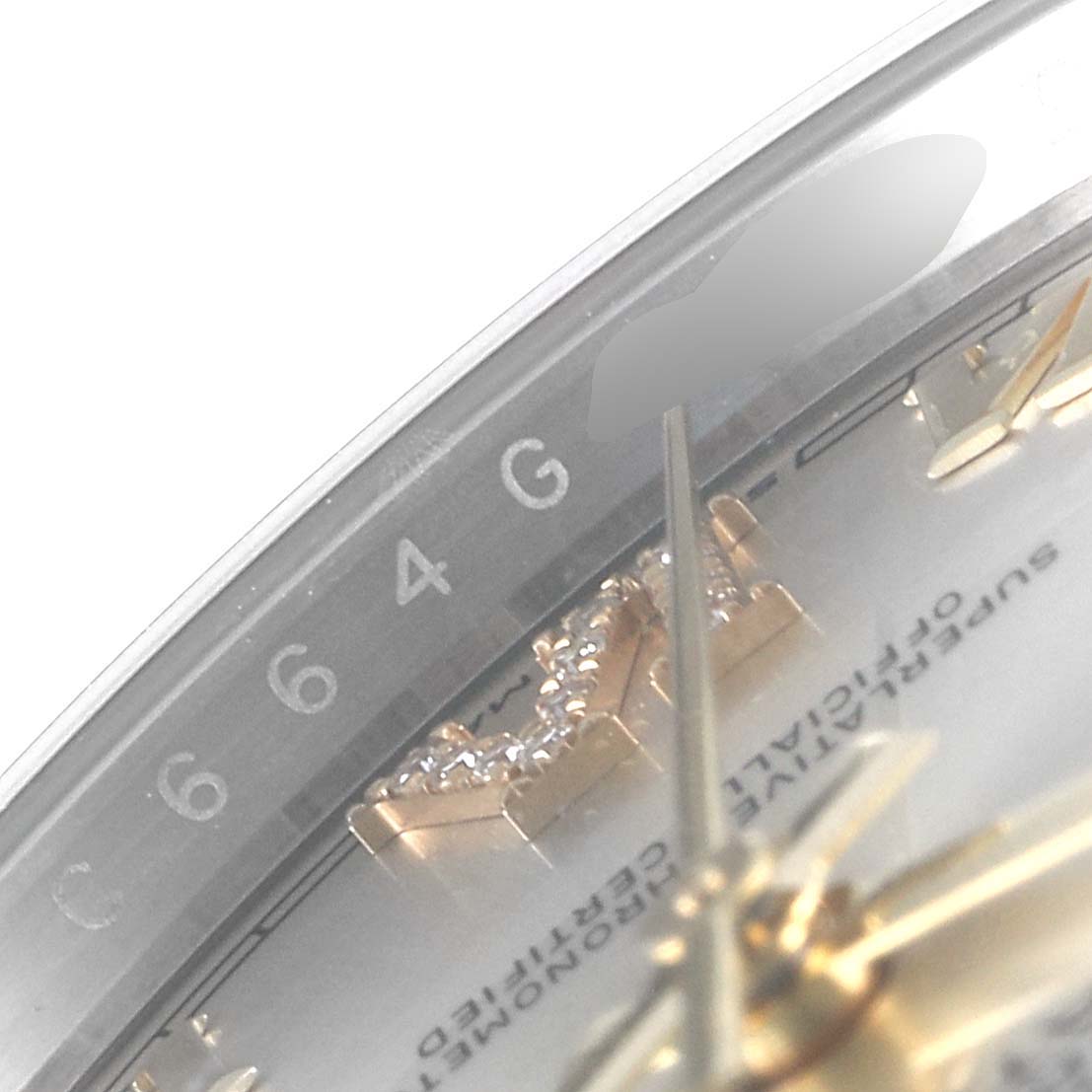 The image displays a close-up of the dial and part of the bezel of a Rolex Datejust 126233 Men's Steel and Gold (two tone) Silver Dial 126233 Men's Steel and Gold (two tone) Silver Dial watch, highlighting the hour markers and part of the inscription.