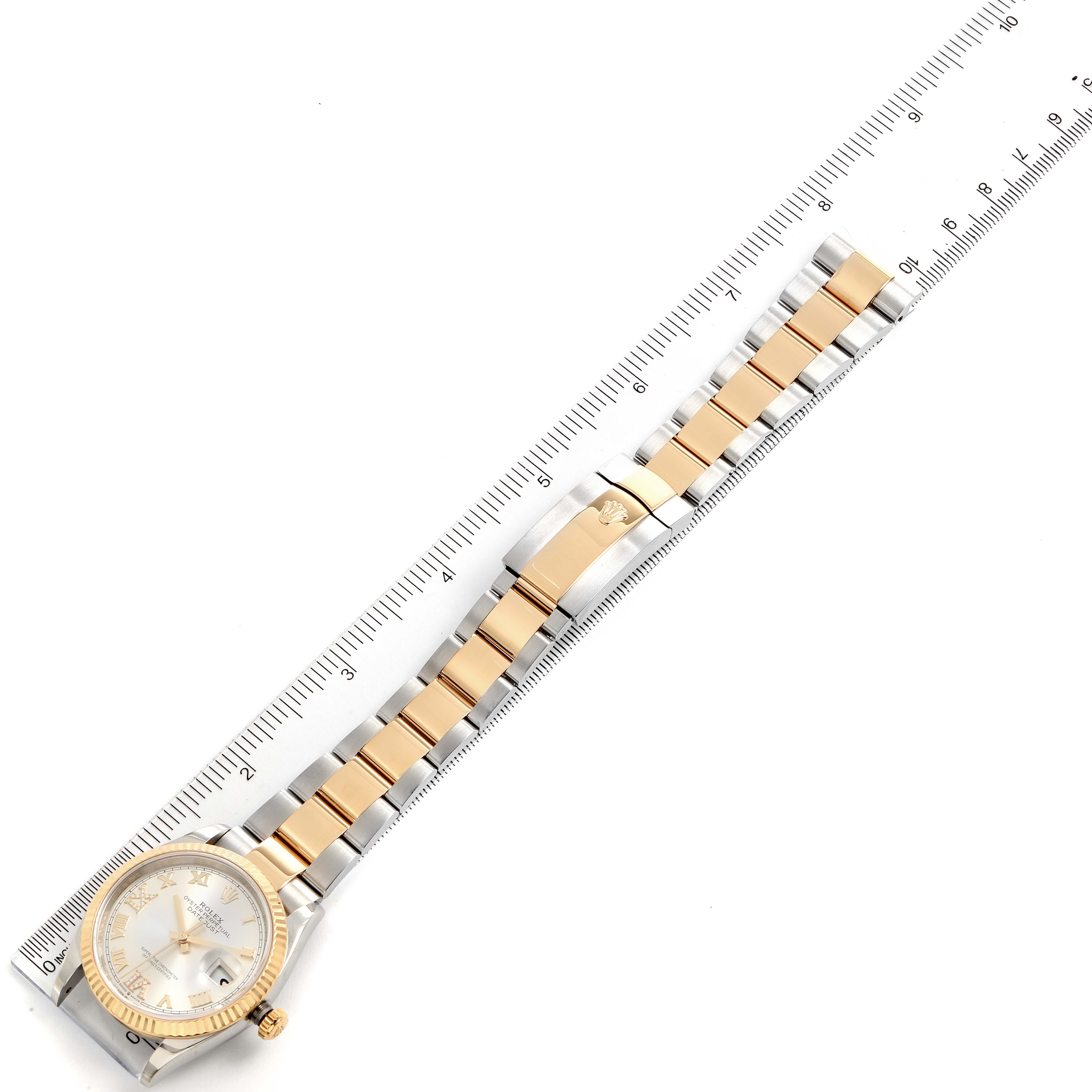 The image shows a Rolex Datejust 126233 Men's Steel and Gold (two tone) Silver Dial 126233 Men's Steel and Gold (two tone) Silver Dial watch with a two-tone metal strap and clasp, measured alongside a ruler.