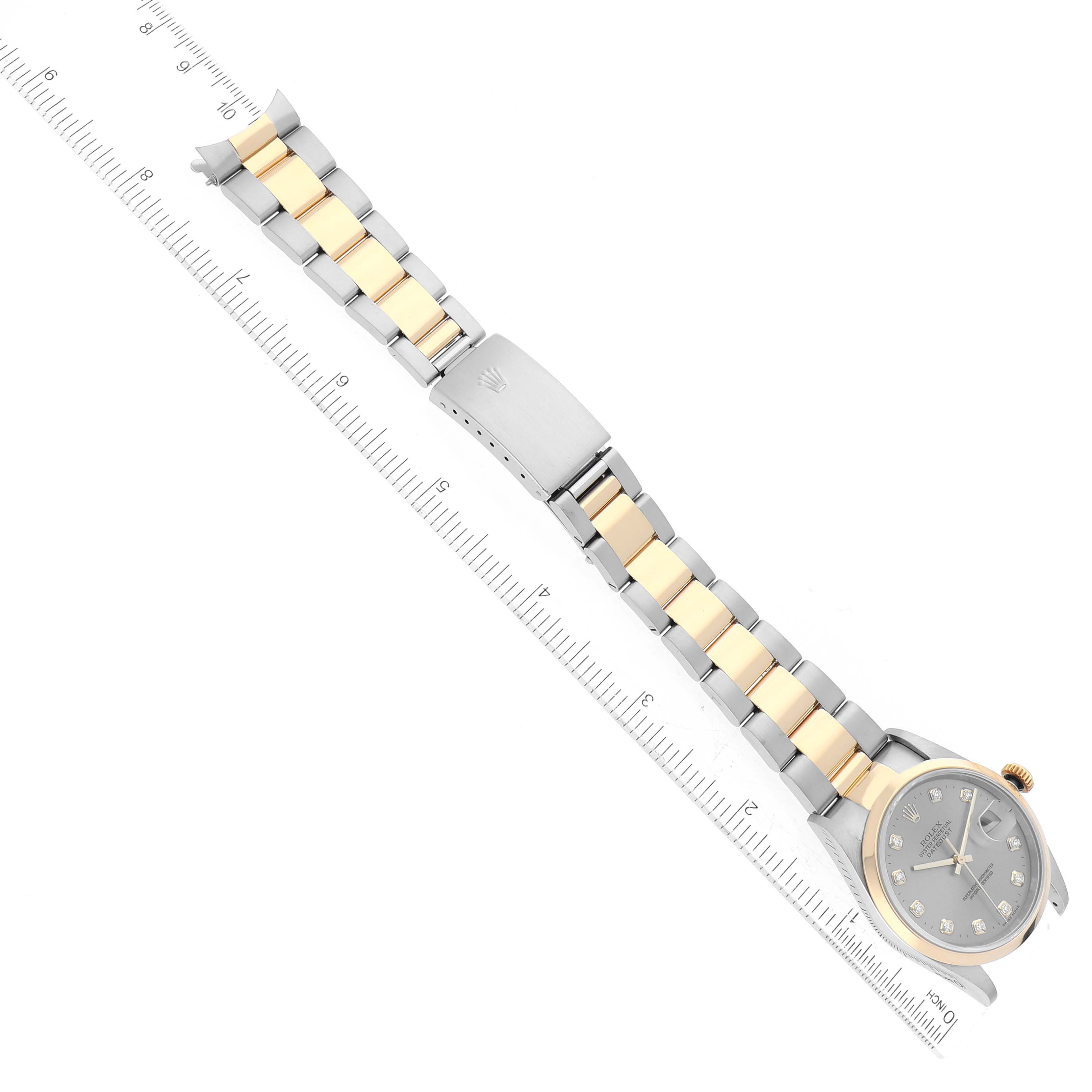The image shows a top-down view of a Rolex Datejust 16203 Men's Steel and Gold (two tone) Grey Dial 16203 Men's Steel and Gold (two tone) Grey Dial watch, including the dial, bracelet, and clasp, alongside a measuring ruler.