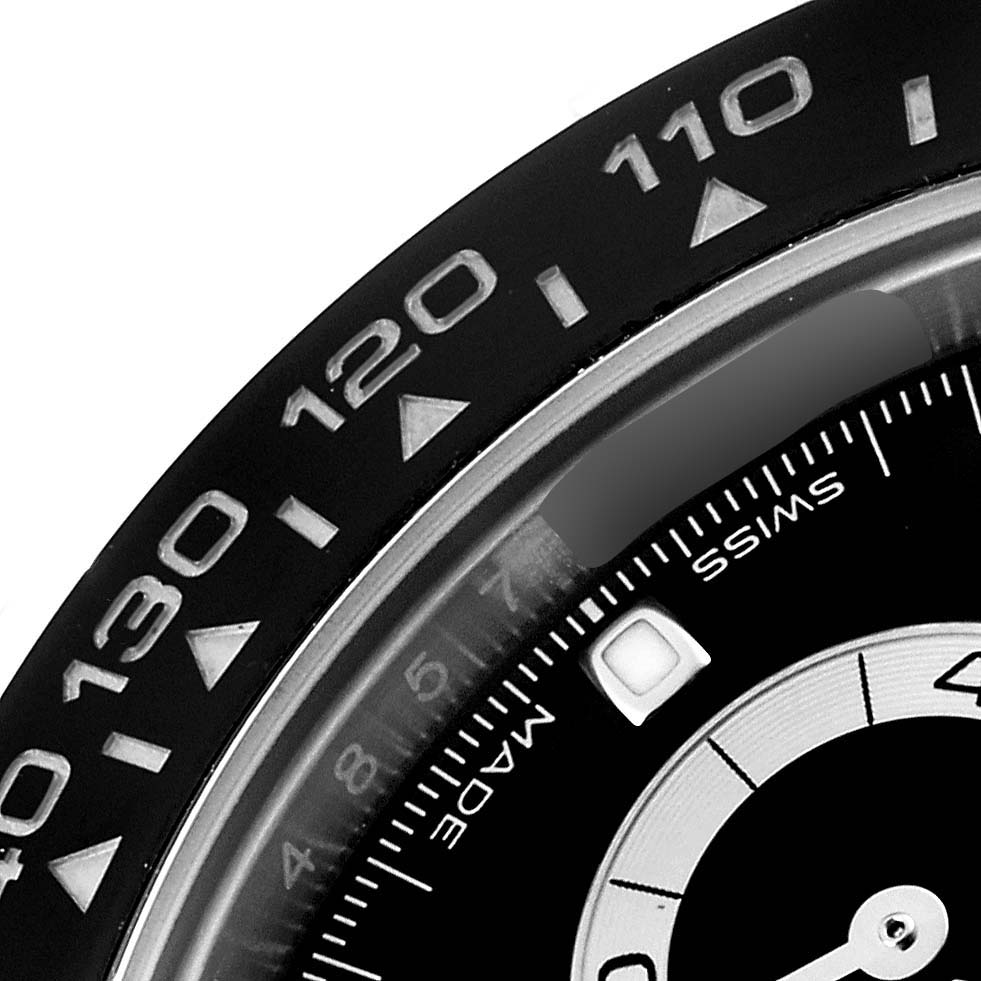 This image shows a close-up of the bezel and dial of a Rolex Daytona 116500LN Men's Stainless Steel Black Dial 116500LN Men's Stainless Steel Black Dial watch displaying numbers and the words "Swiss Made".