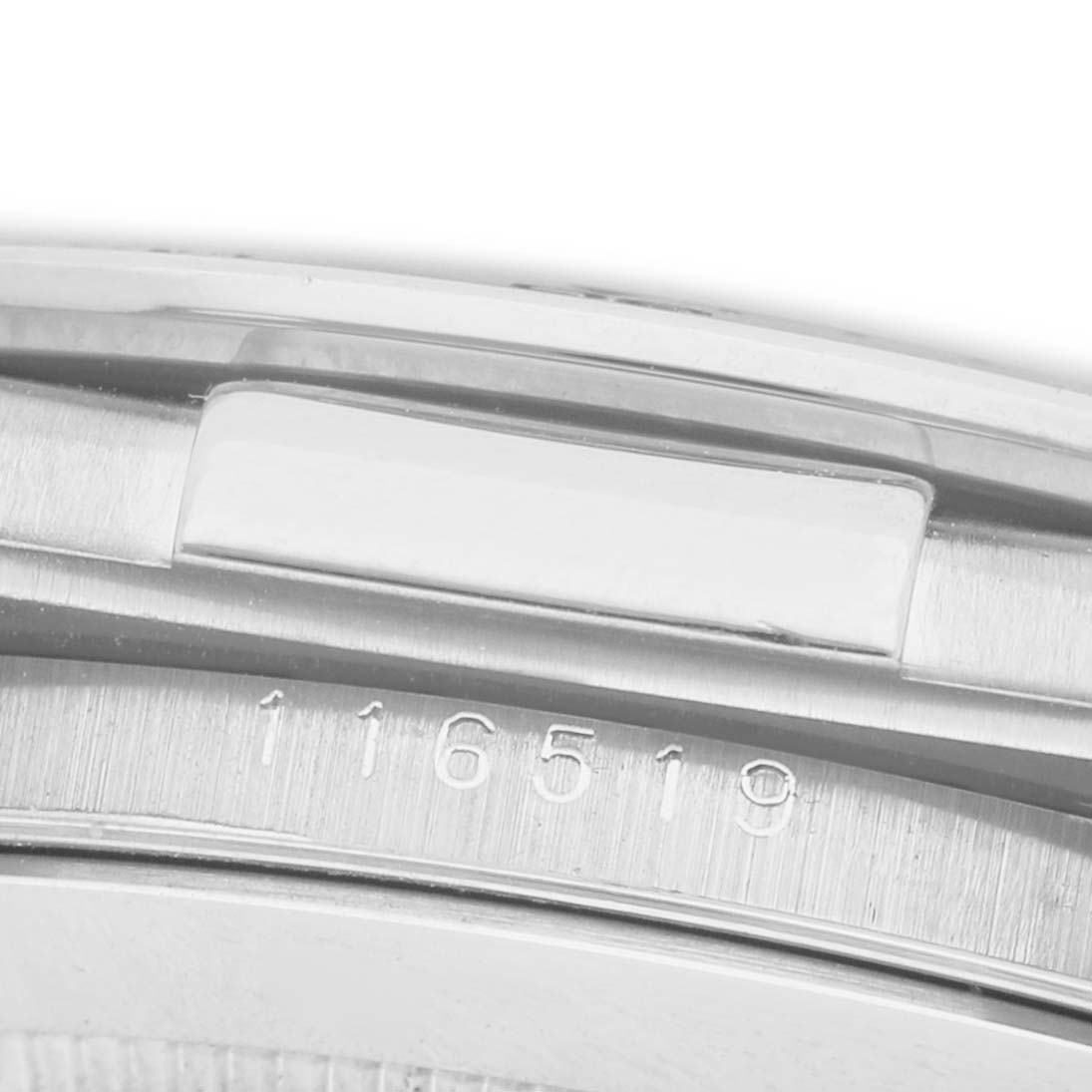The image shows a side view of a Rolex Daytona 116519 Men's White Gold Silver Dial watch case, highlighting the brushed metal finish and model number engraving.