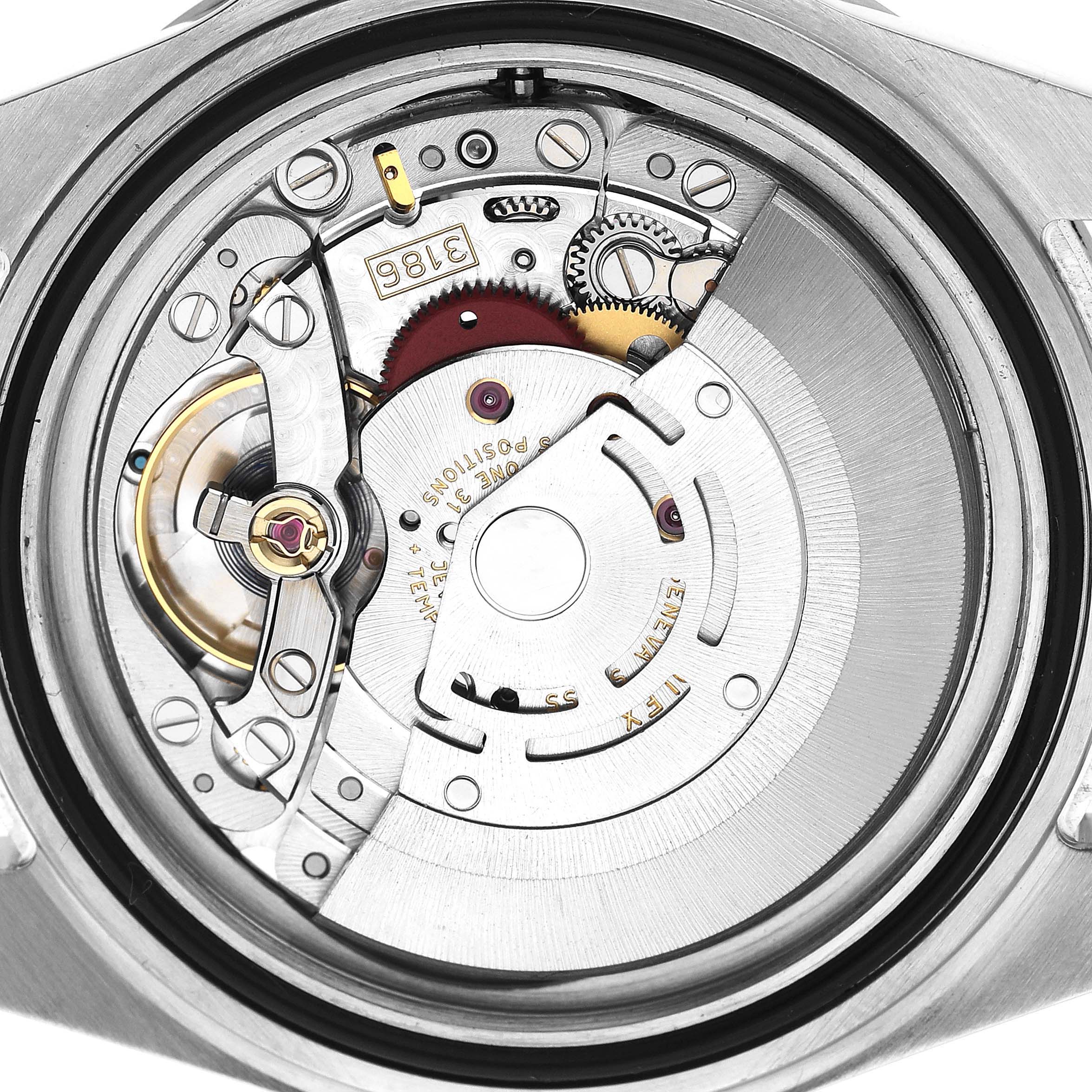 The image shows the internal movement mechanism of a Rolex Explorer 16570 T Men's Stainless Steel Black Dial watch from a top-down angle, highlighting gears and components.