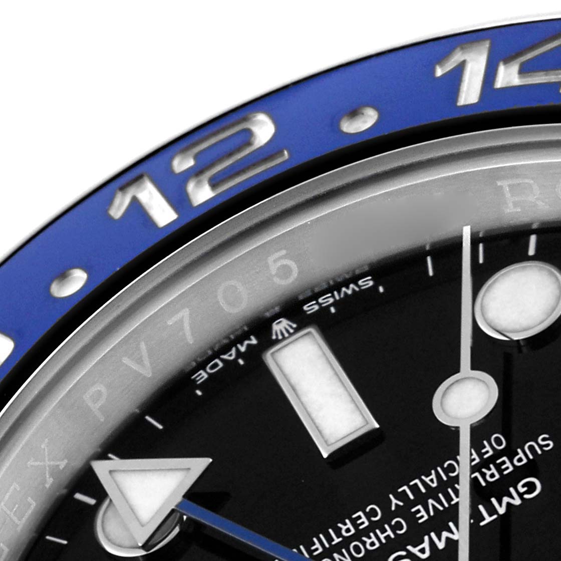 The image shows a close-up of the 12 o
clock area, bezel, and part of the dial of a Rolex GMT-Master 126710BLNR Men
s Stainless Steel Black Dial 126710BLNR Men
s Stainless Steel Black Dial watch.