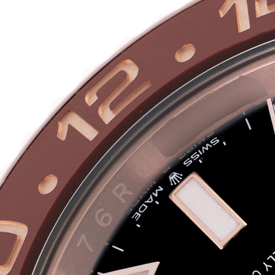 The image shows a close-up of the Rolex GMT-Master 126715CHNR Men
s Rose Gold Black Dial 126715CHNR Men
s Rose Gold Black Dial model, focusing on the bezel and part of the dial.