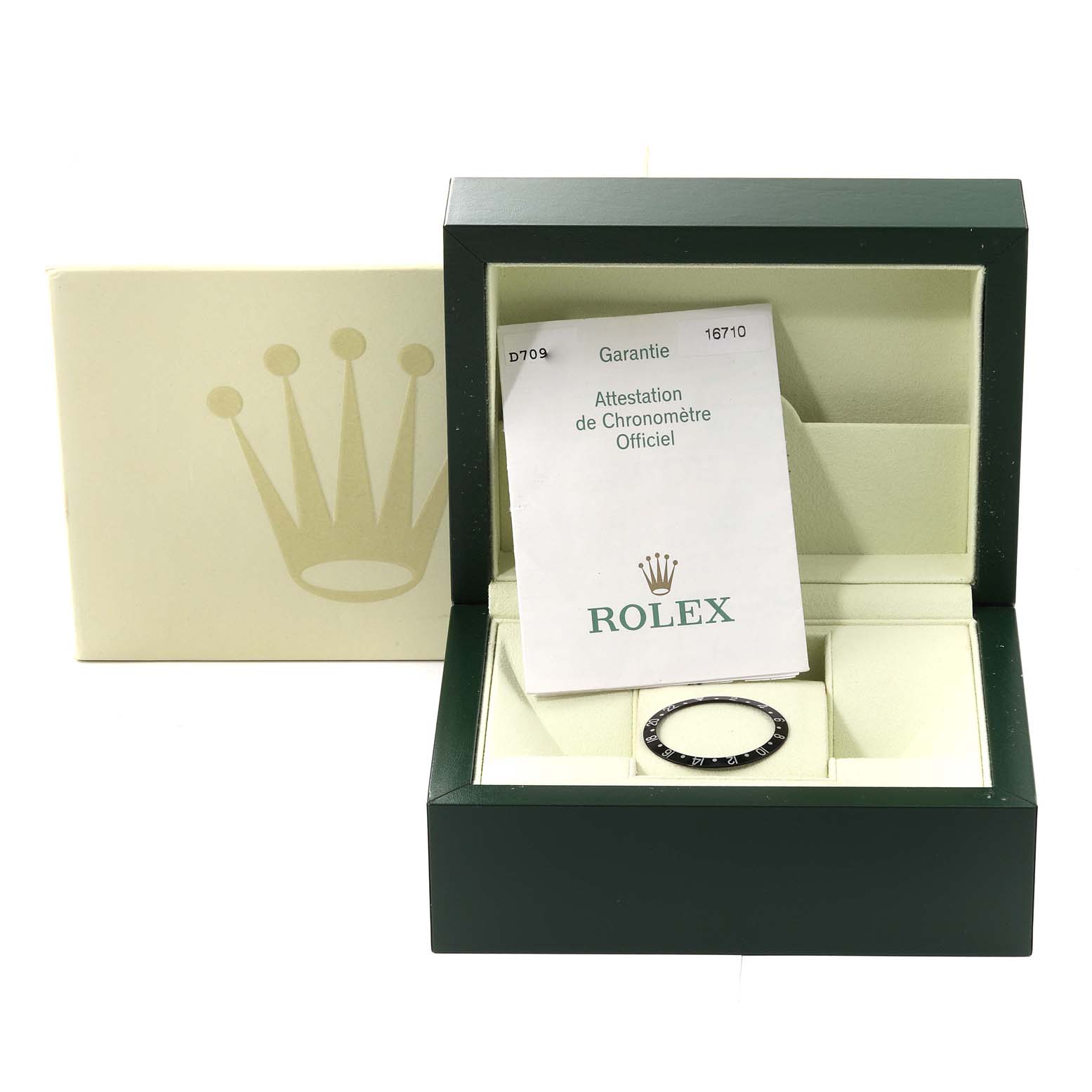 This image shows a Rolex GMT-Master 16710 Men's Stainless Steel Black Dial 16710 Men's Stainless Steel Black Dial watch box, warranty card, and a bezel insert from a front angle.