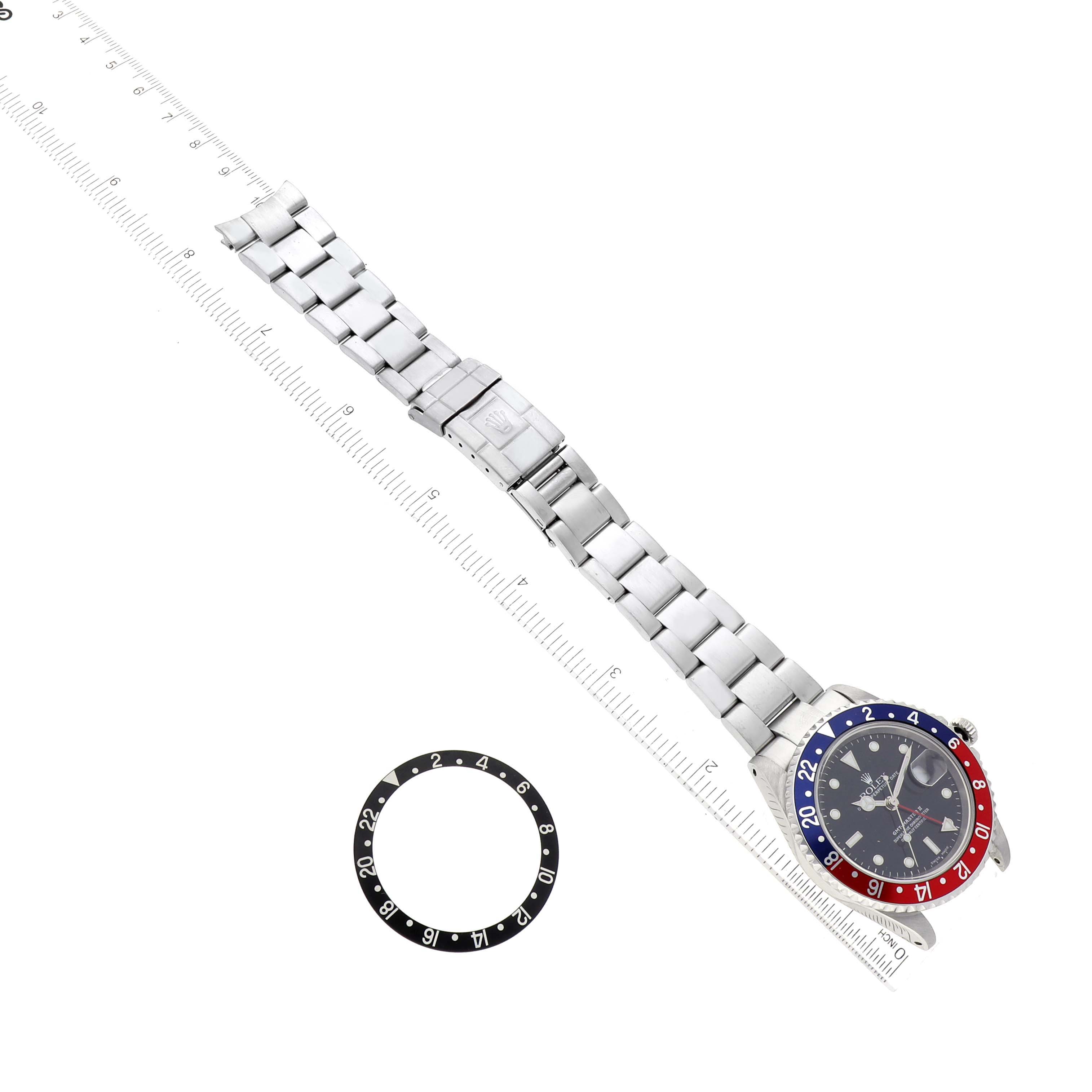 This image shows a Rolex GMT-Master 16710 Men
s Stainless Steel Black Dial 16710 Men
s Stainless Steel Black Dial watch and a spare bezel insert, viewed from above.