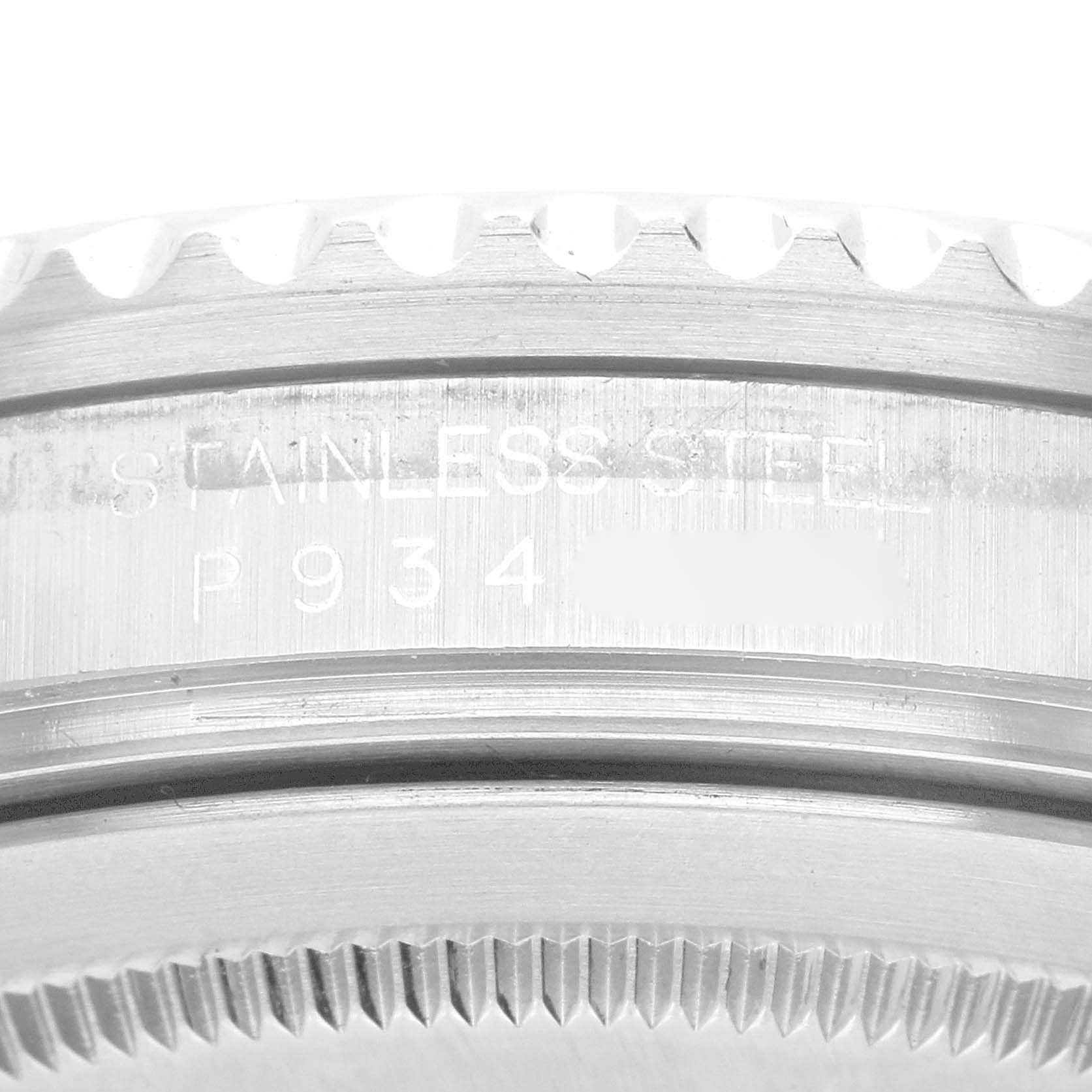 The image shows a close-up of the Rolex GMT-Master 16710 Men
s Stainless Steel Black Dial 16710 Men
s Stainless Steel Black Dial’s stainless steel case with part of its fluted bezel.