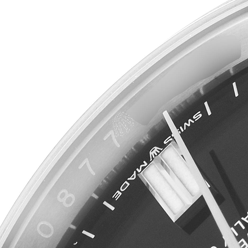 This close-up angle of the Rolex Oyster Perpetual 126000 Men's Stainless Steel Black Dial 126000 Men's Stainless Steel Black Dial watch shows the minute hand and part of the dial marked "Swiss Made."