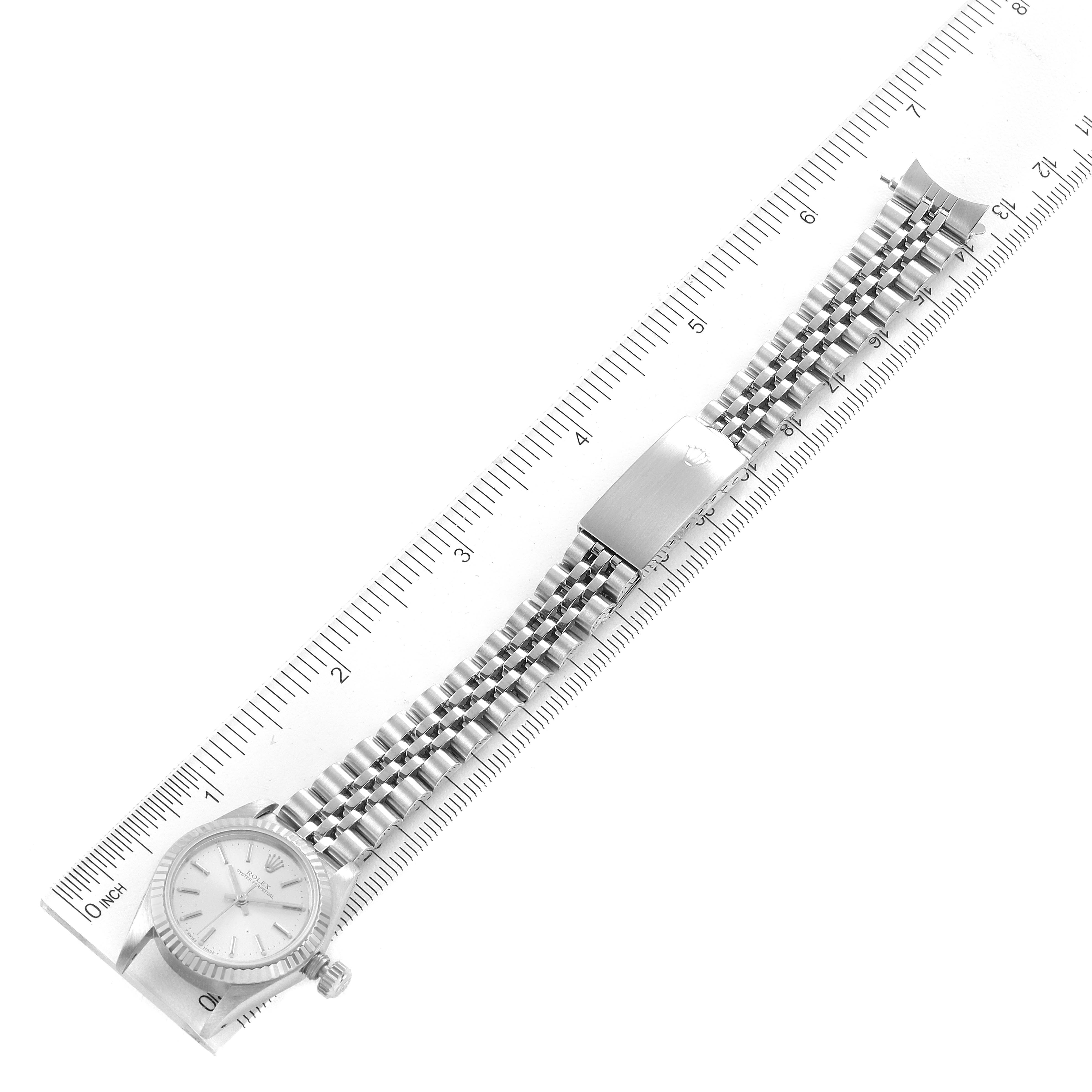This image shows the front view of the face and entire band of a Rolex Oyster Perpetual 67194 Women
s Stainless Steel Silver Dial 67194 Women
s Stainless Steel Silver Dial watch against a ruler for scale.