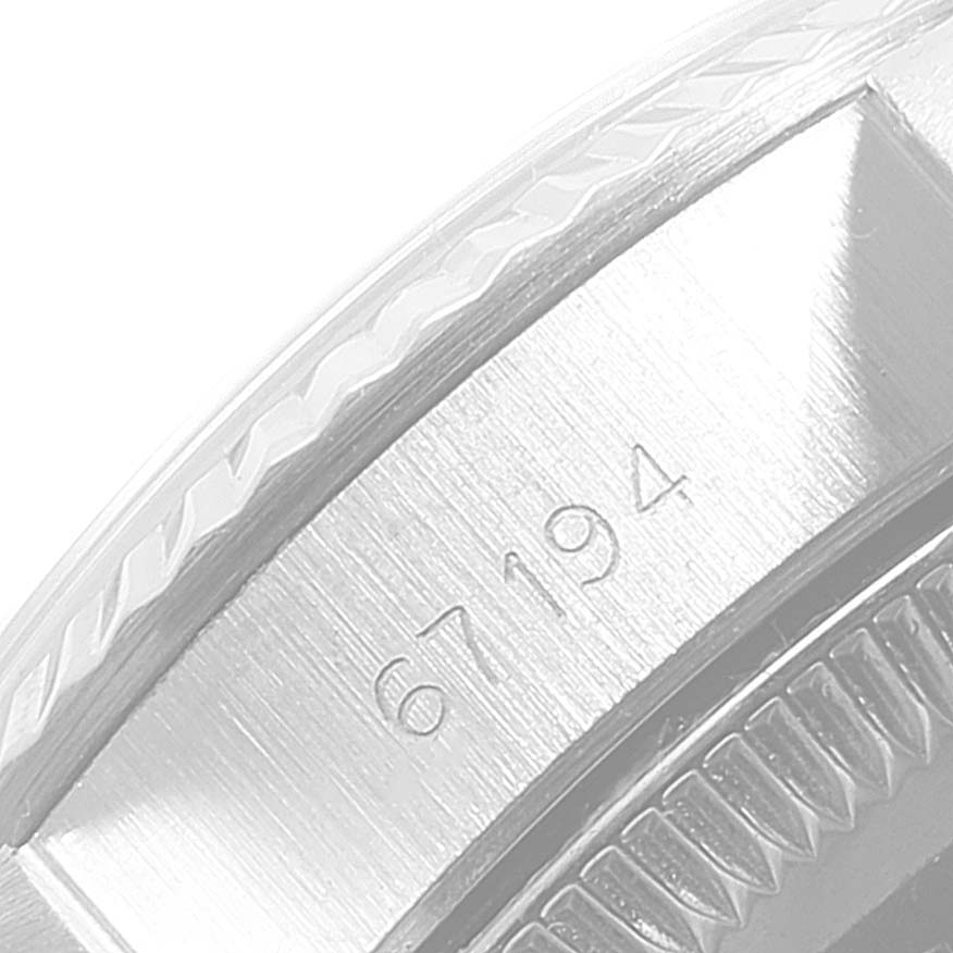 This image shows a close-up of the side edge of the bezel and case of a Rolex Oyster Perpetual 67194 Women
s Stainless Steel Silver Dial 67194 Women
s Stainless Steel Silver Dial watch.