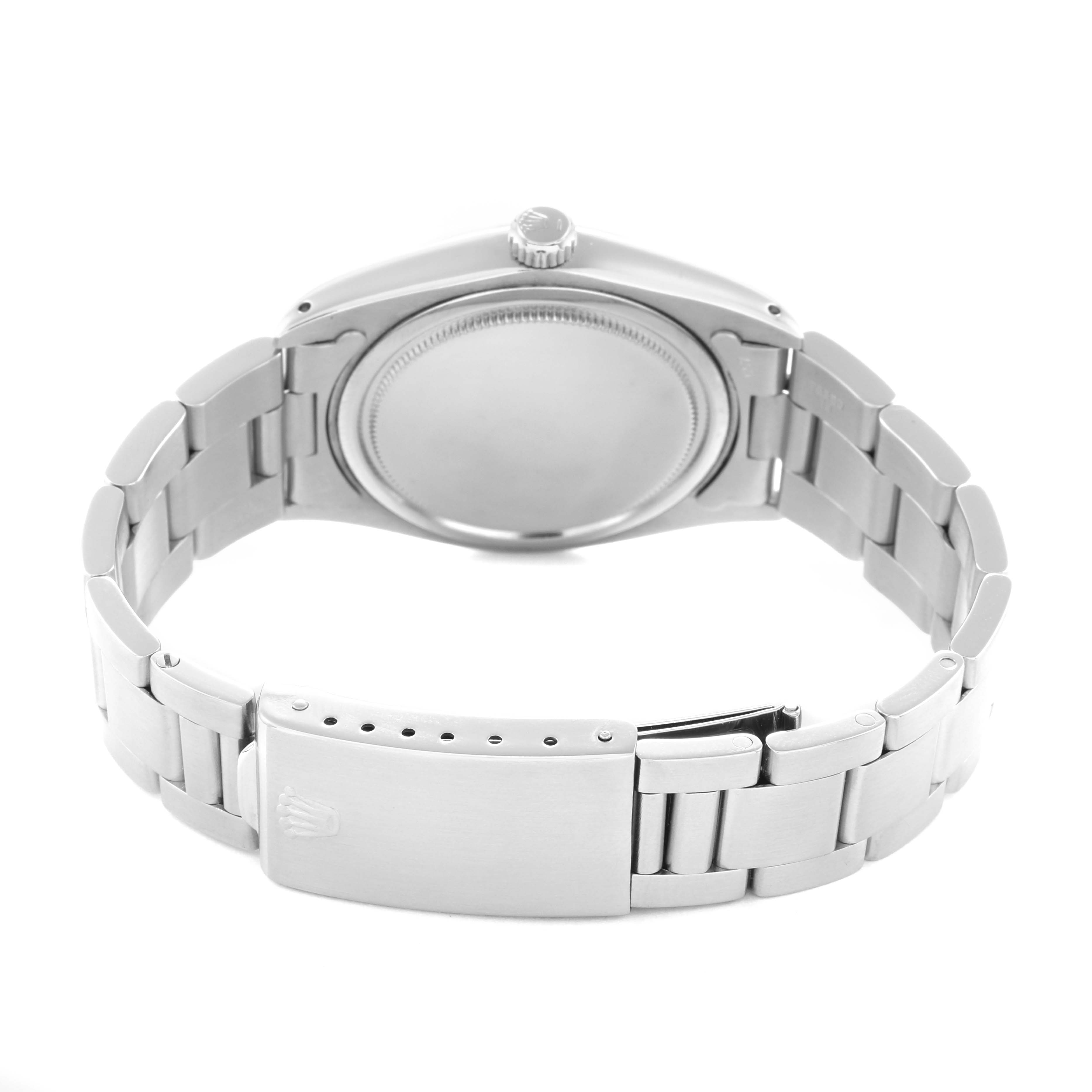The image shows the back of a Rolex Date 6694 Men's Stainless Steel Black Dial watch, highlighting the bracelet, clasp, case back, and crown.