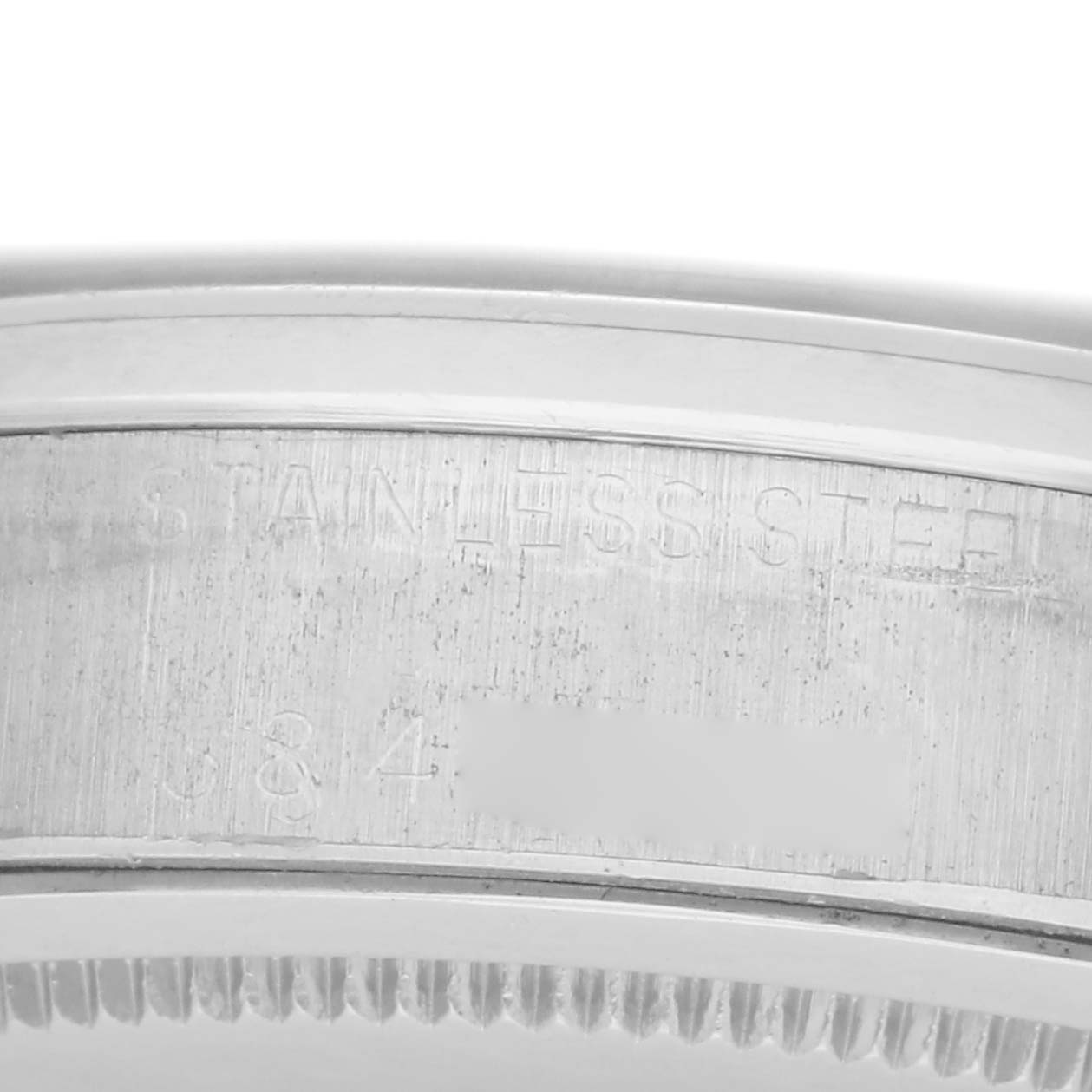 The image shows the side view of a Rolex Date 6694 Men's Stainless Steel Black Dial model, highlighting the stainless steel case and engravings.