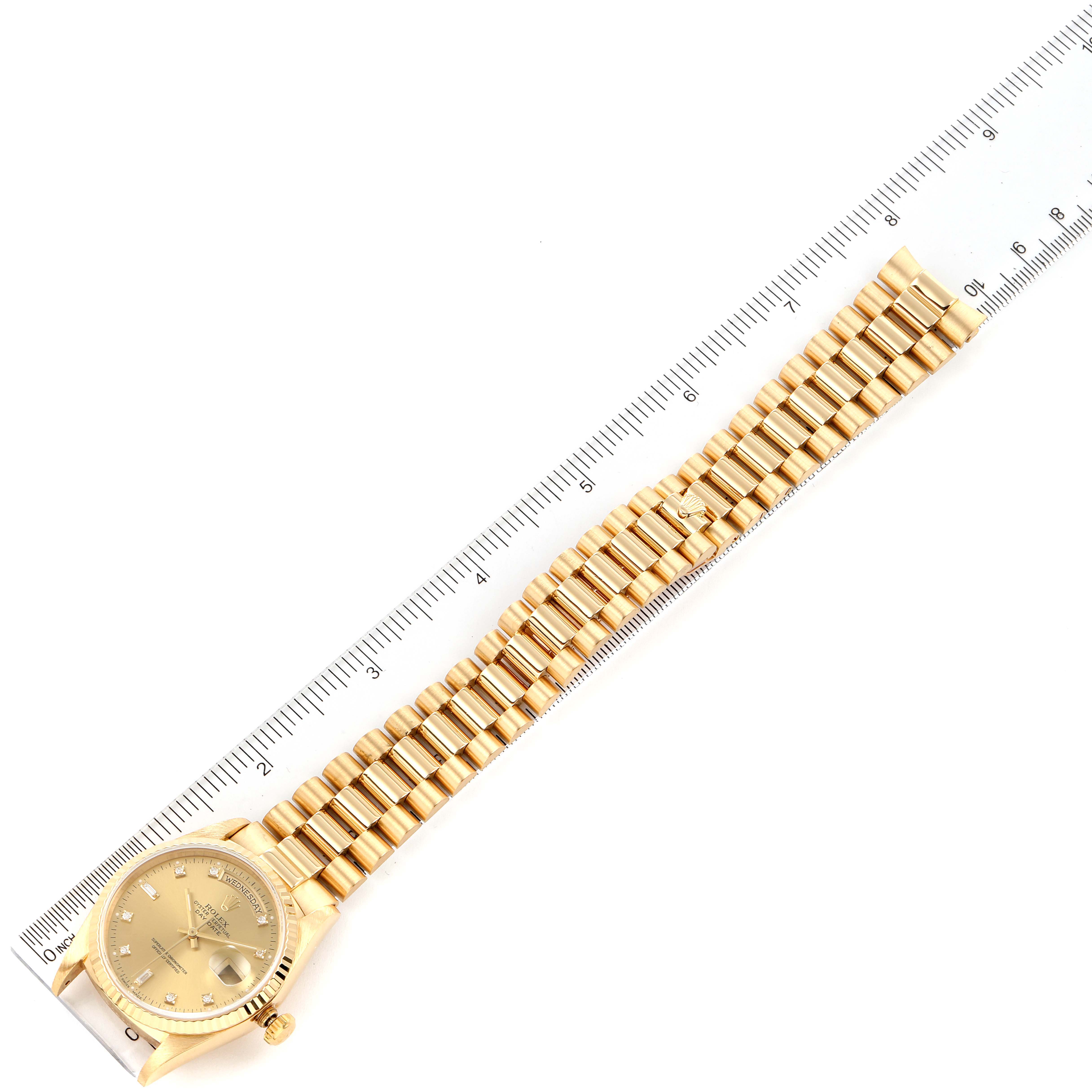 The image shows a top-down view of a Rolex President 18238 Men's Yellow Gold Champagne Dial 18238 Men's Yellow Gold Champagne Dial model watch alongside a ruler, displaying the case, dial, and bracelet.