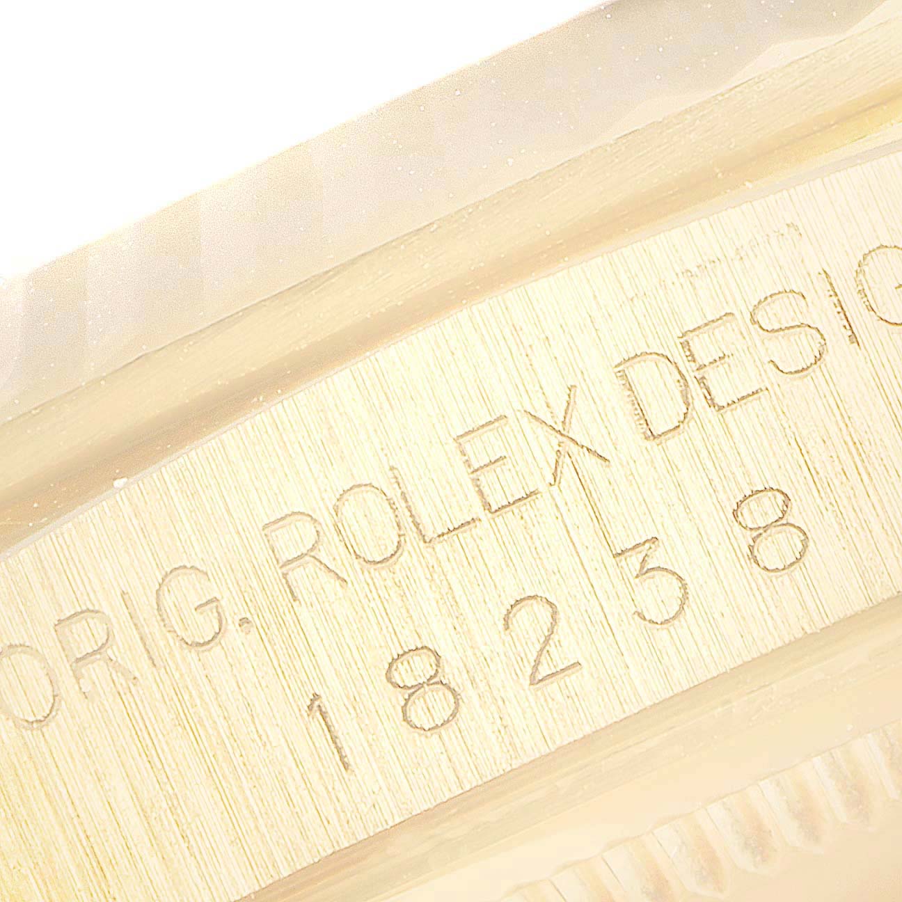 This image shows a close-up of the engraved serial number on the side of a Rolex President 18238 Men's Yellow Gold Champagne Dial 18238 Men's Yellow Gold Champagne Dial model watch.