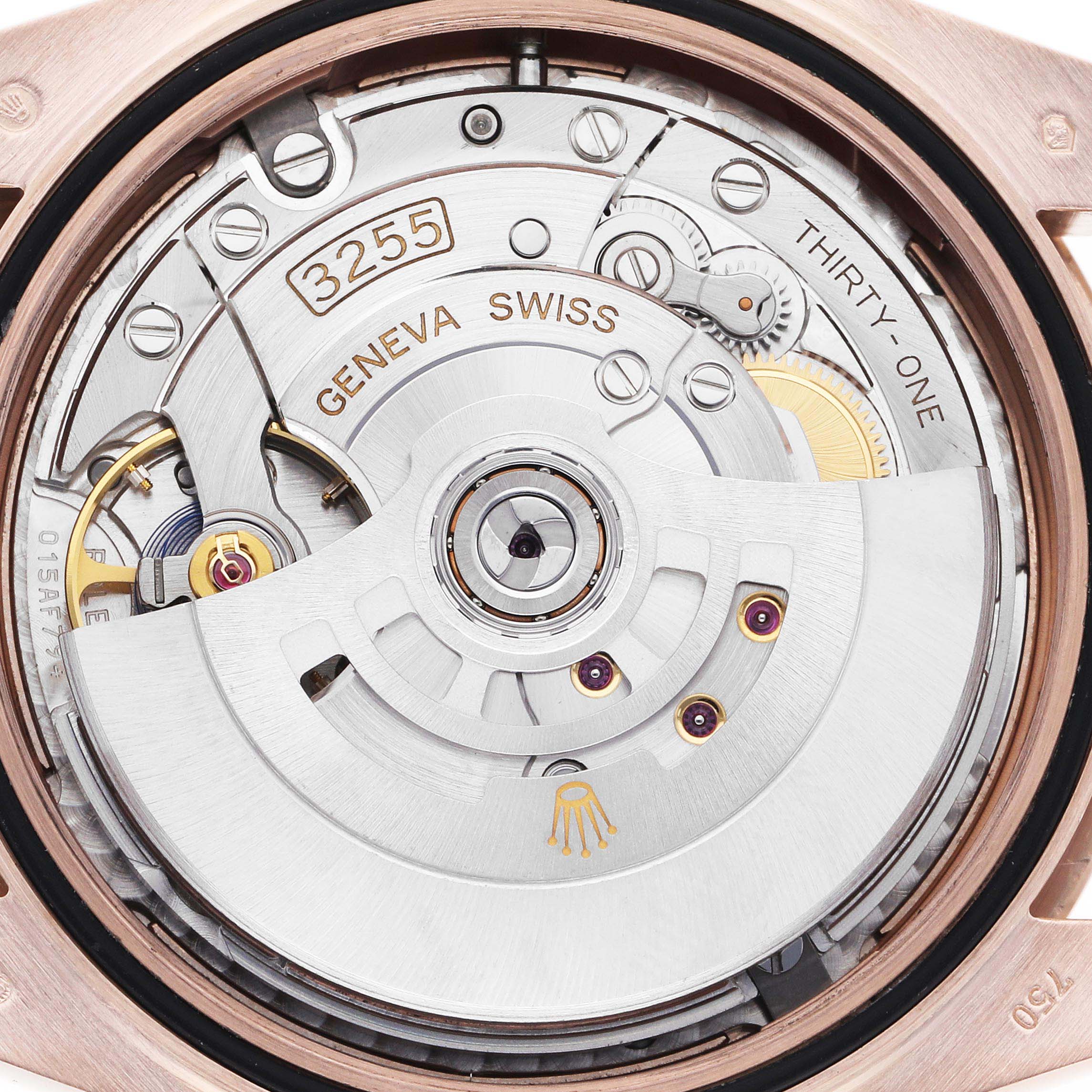 The image shows the movement of the Rolex President 228235 Men's Rose Gold Pink Dial 228235 Men's Rose Gold Pink Dial model watch, viewed from the back, displaying the rotor and intricate gears.