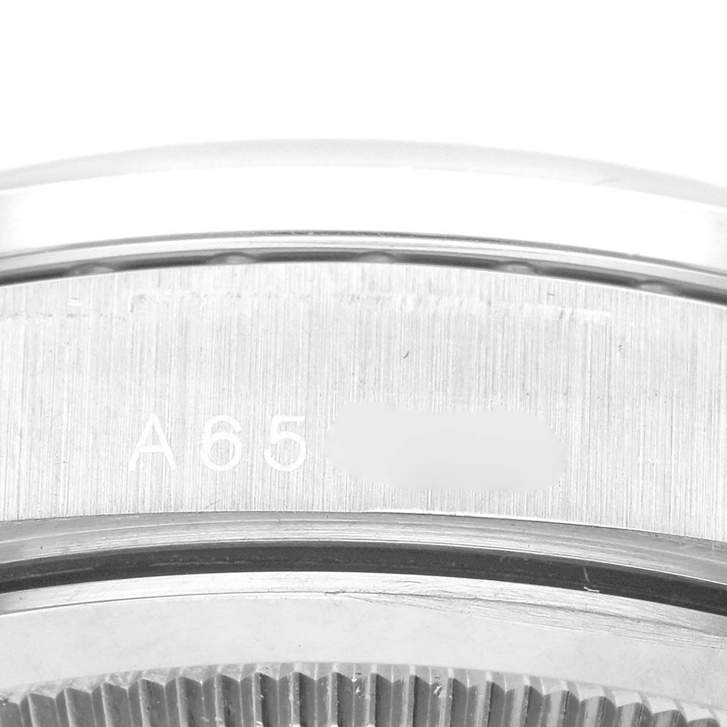 This image shows a close-up view of the side and case back of a Rolex President 18389MG Men's White Gold Blue Dial 18389MG Men's White Gold Blue Dial model watch, displaying part of the serial number.