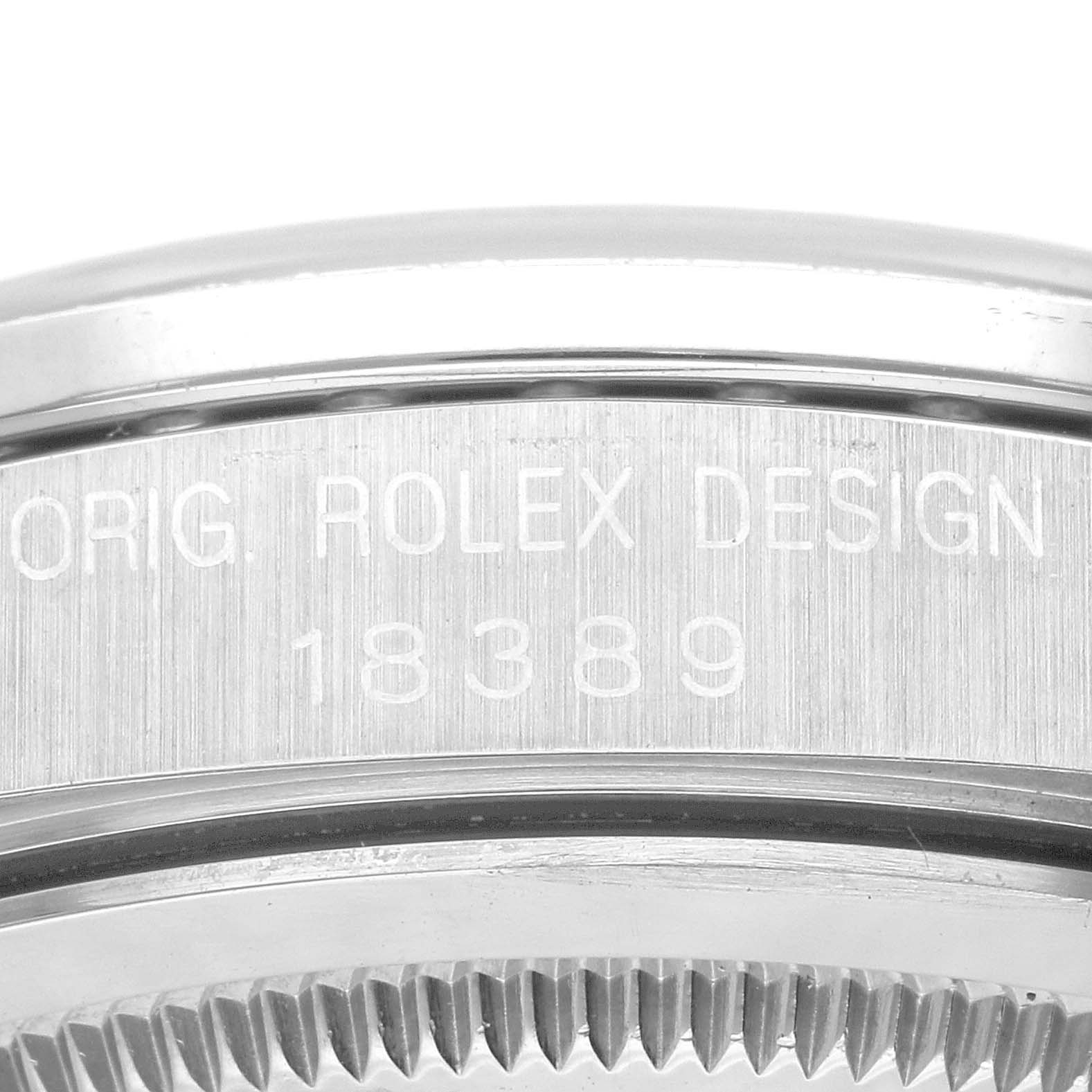 The image shows a close-up of the side of the case of a Rolex President 18389MG Men's White Gold Blue Dial 18389MG Men's White Gold Blue Dial model, featuring the engraved text “ORIG. ROLEX DESIGN 18389.”
