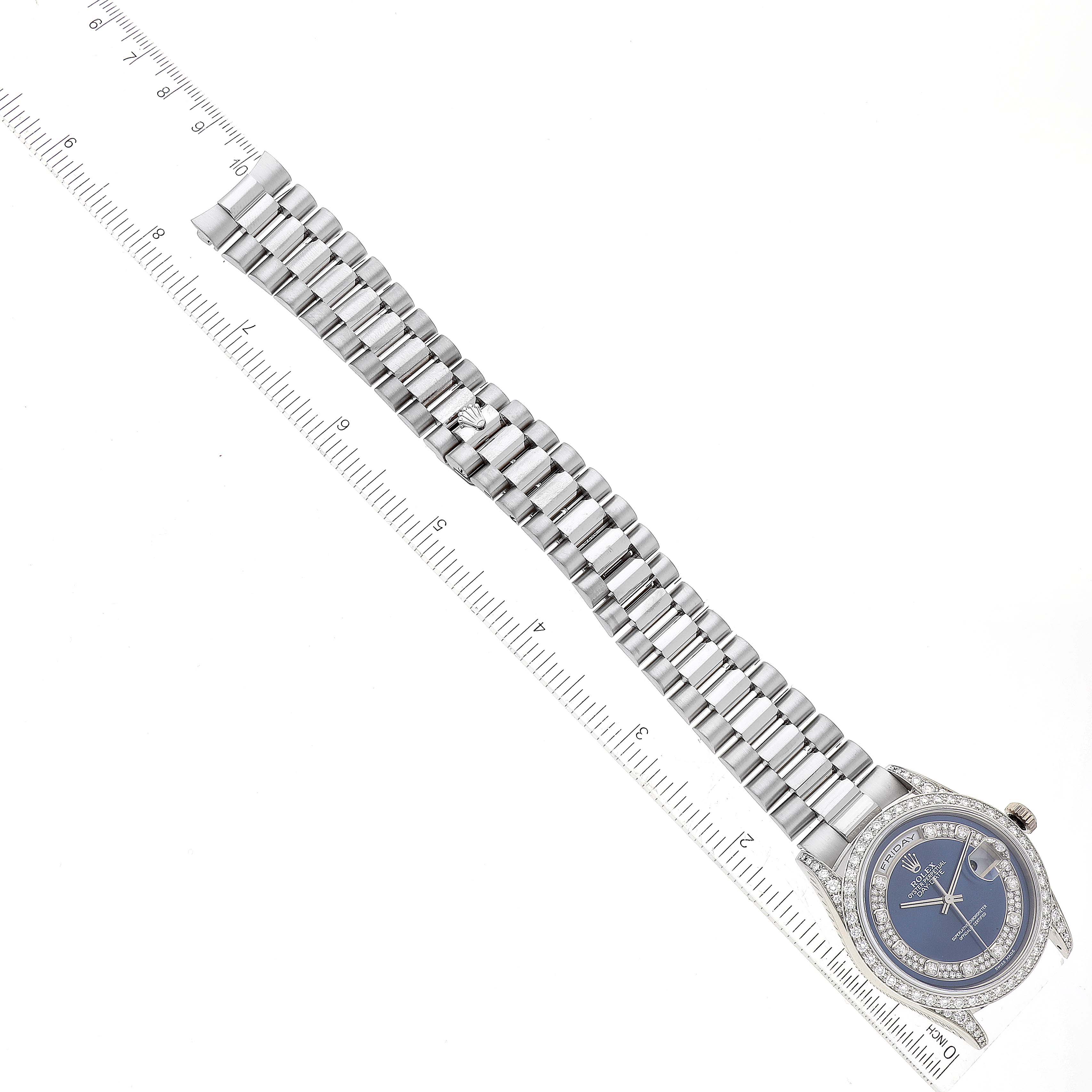 The image shows a Rolex President 18389MG Men's White Gold Blue Dial 18389MG Men's White Gold Blue Dial model watch lying flat with the dial, bezel, and full bracelet visible next to a ruler for scale.